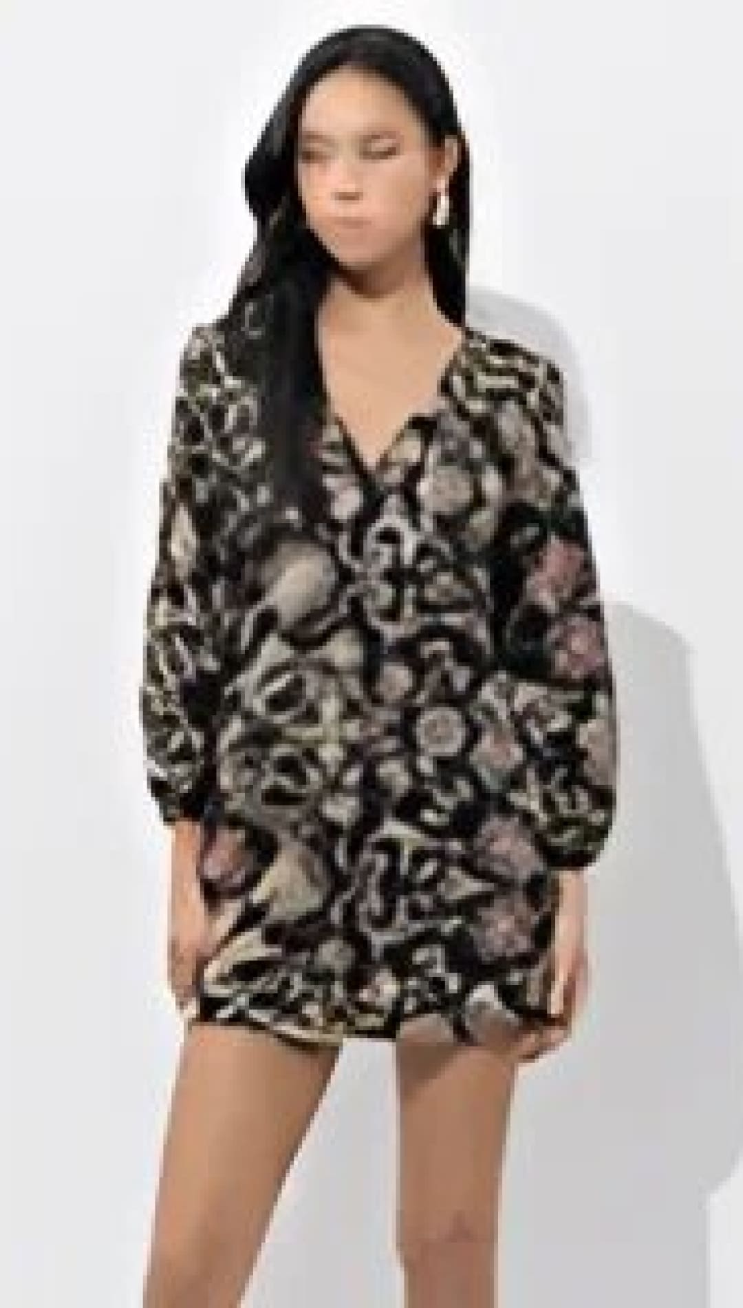 Black and white floral print romper with button-down front.