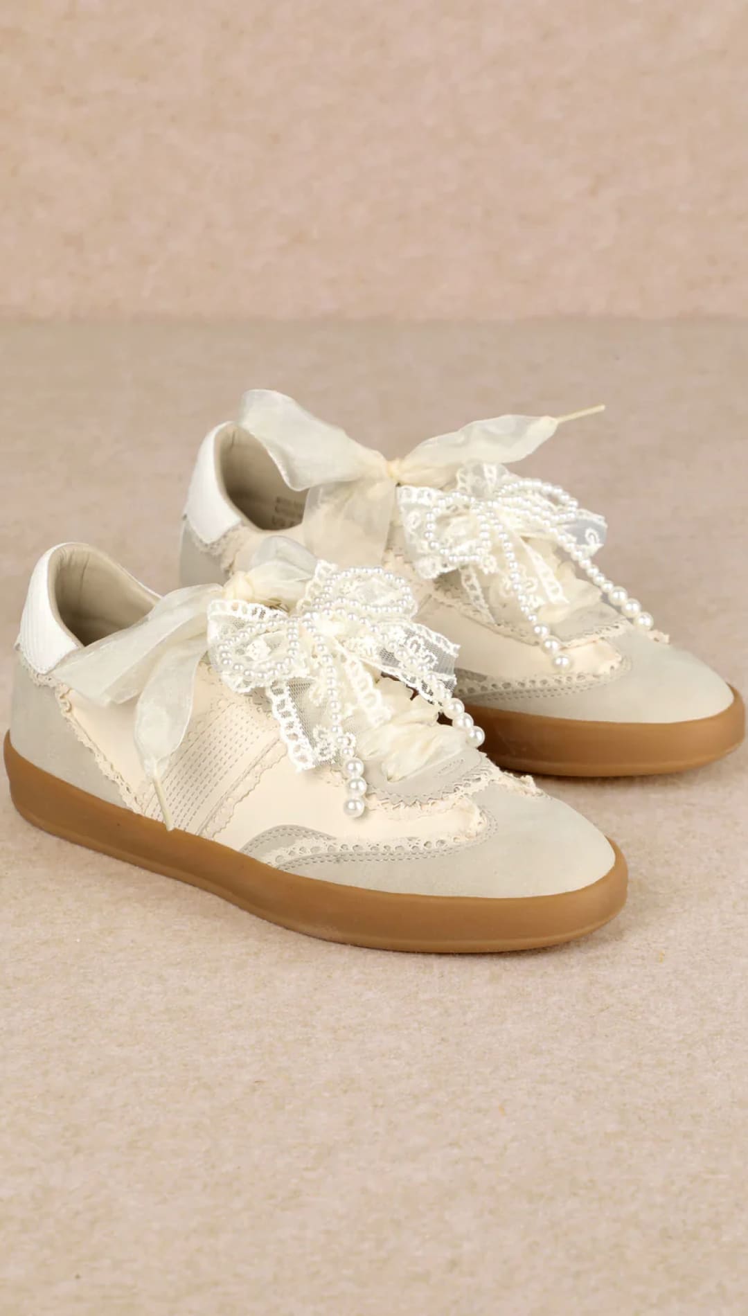 White lace sneakers with gum soles and laces.