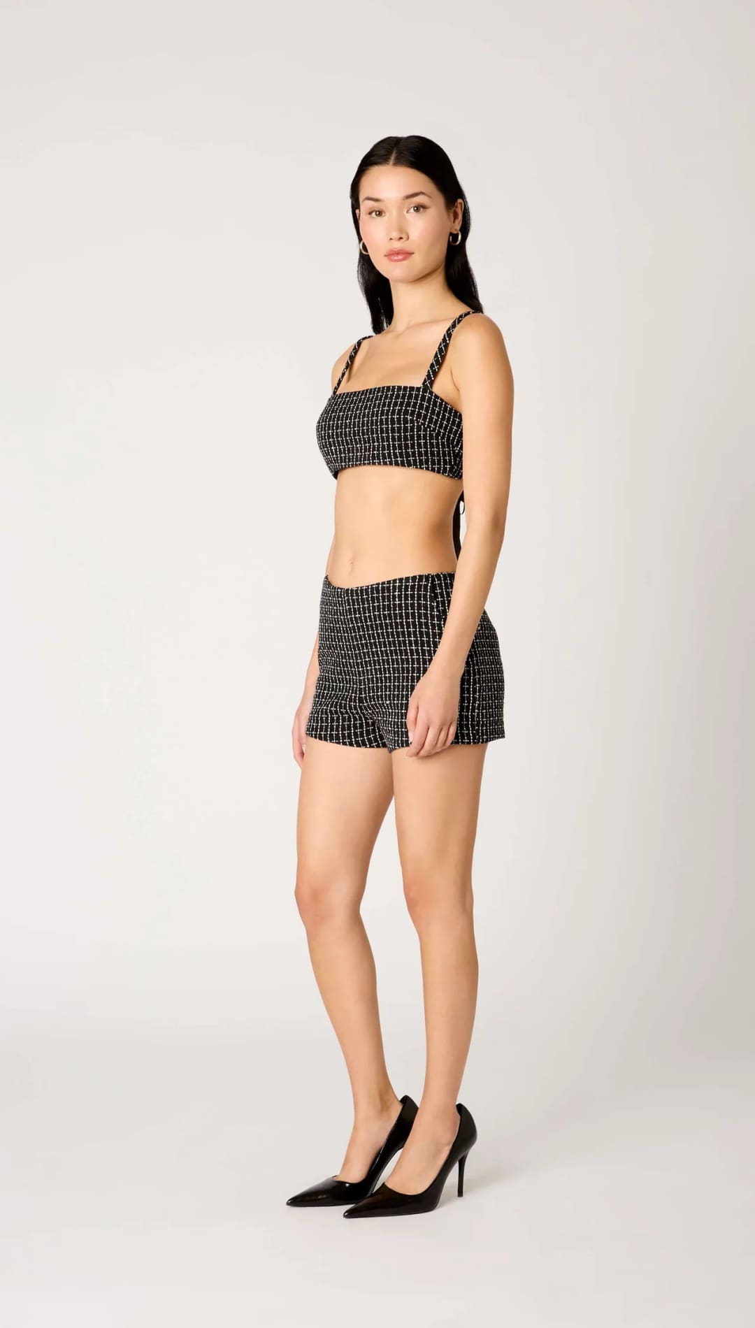 Black and white checkered mini skirt with thin straps.