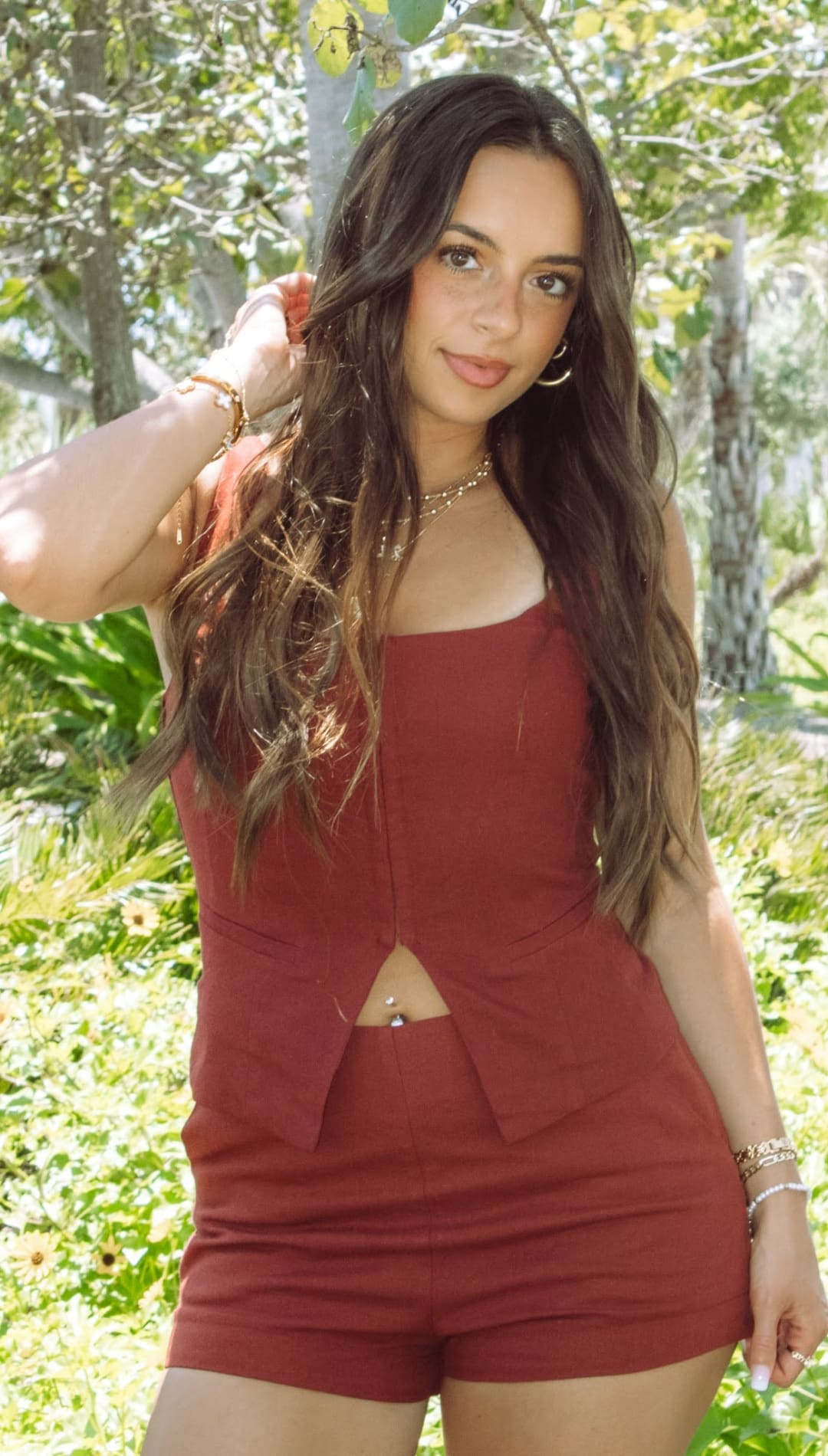 Woman in matching rust-colored shorts and top.