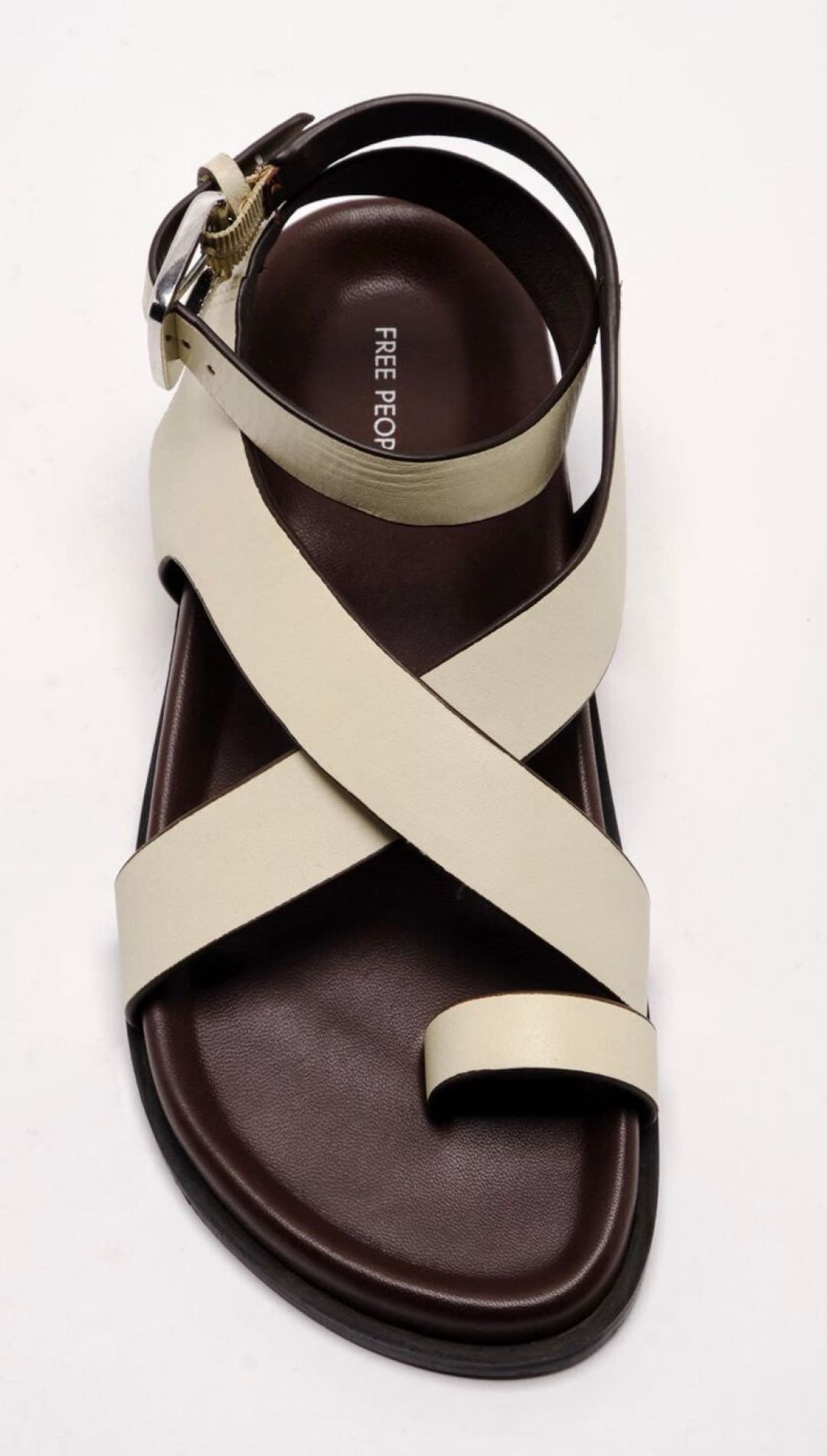 Cream-colored leather sandal with toe loop.
