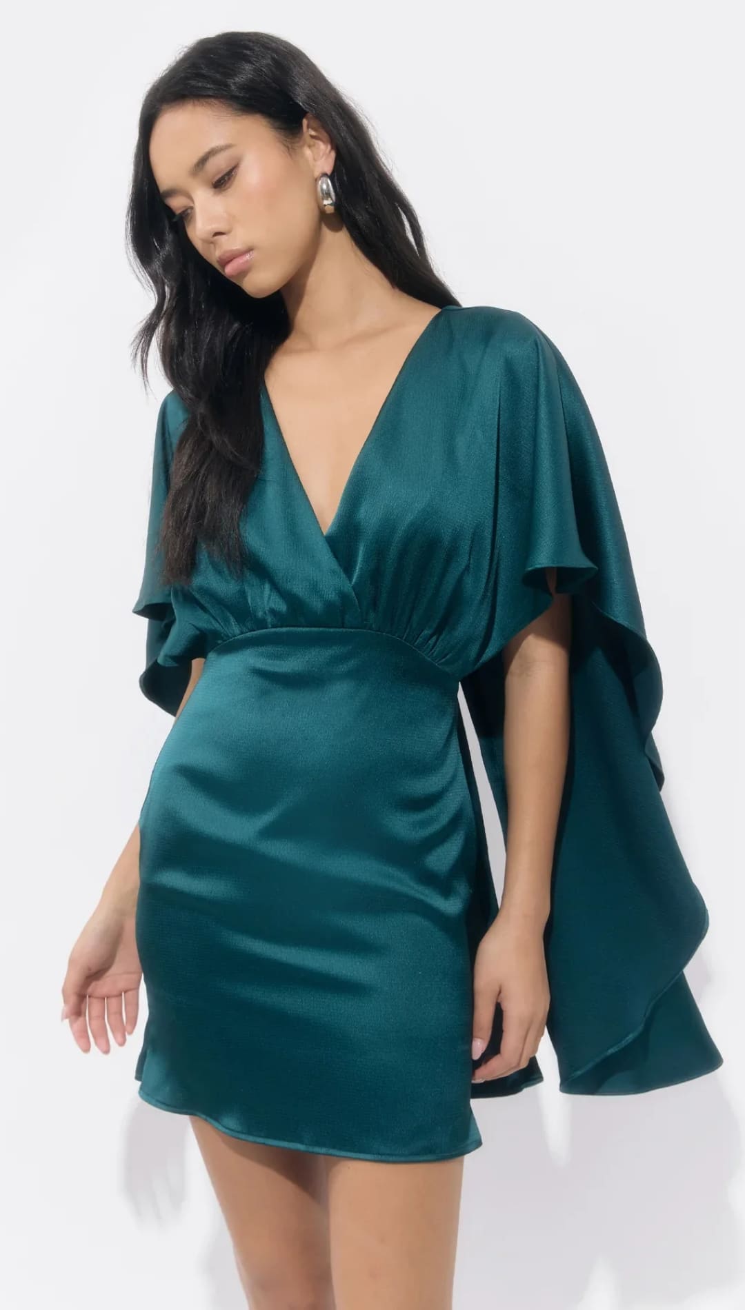 Emerald green satin mini dress with ruffled sleeves and deep v-neckline.