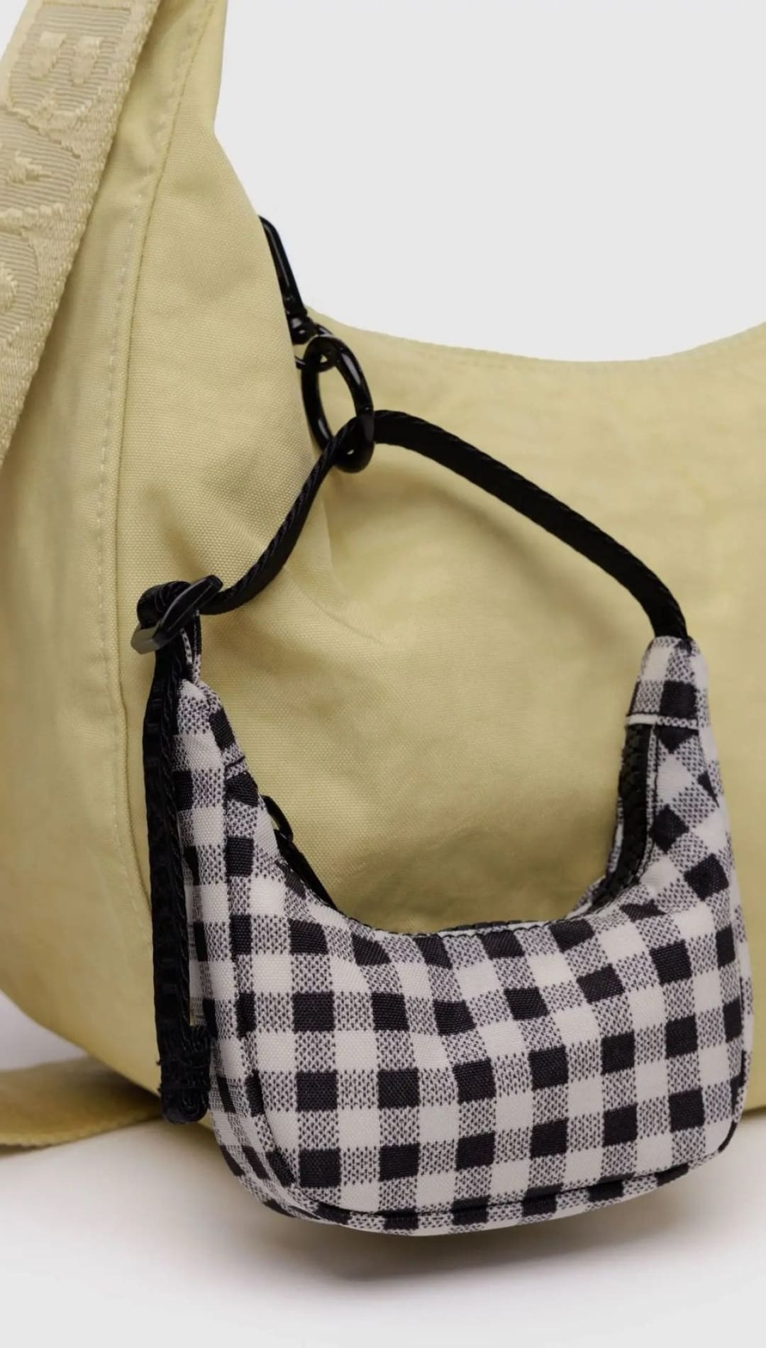 Beige hobo bag with checkered mini bag.