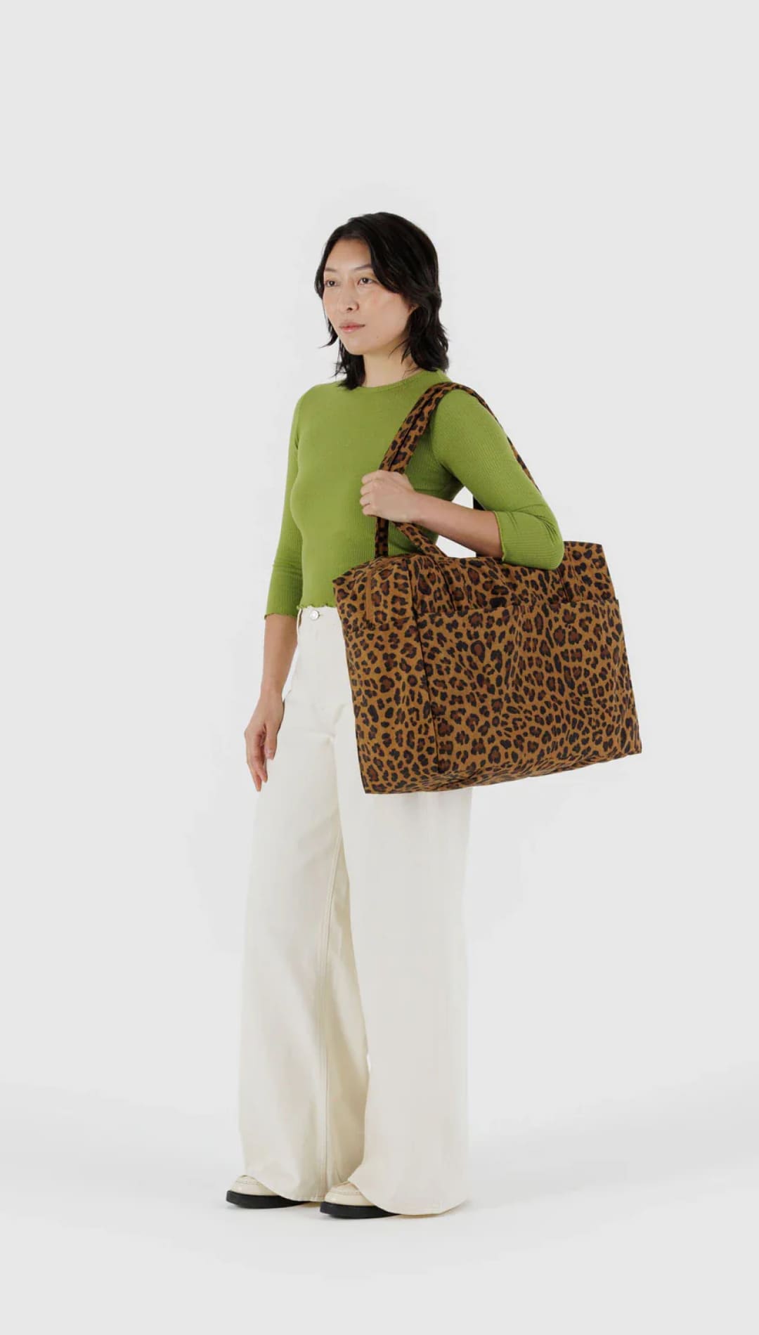 Leopard print tote bag with brown and black spots, made of canvas material.