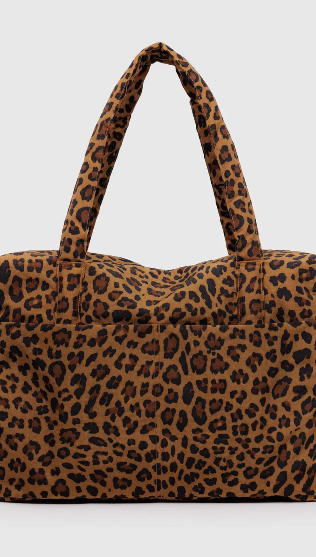 Leopard print tote bag with brown and black spots on a tan background, made of fabric.