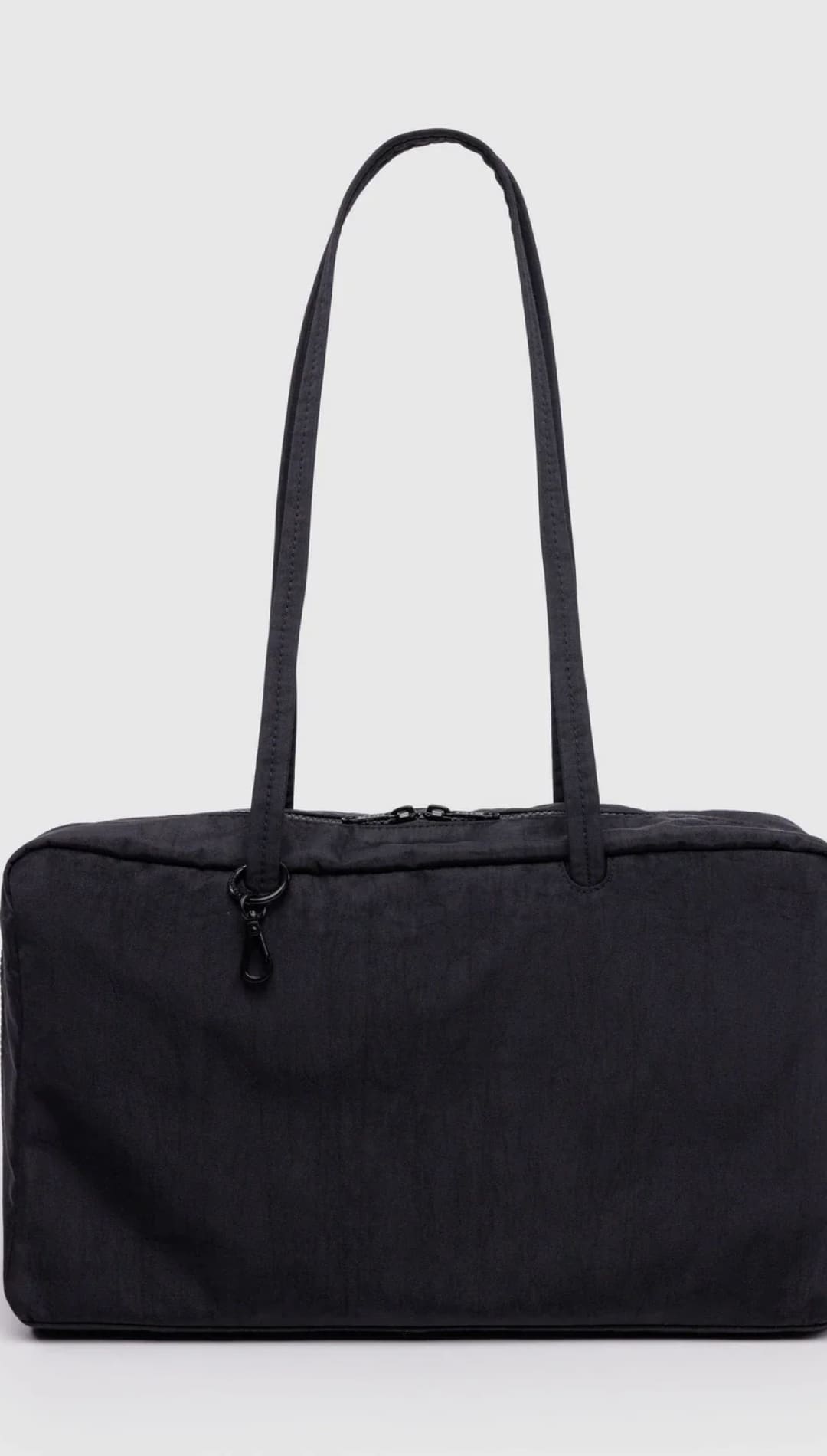 Black nylon tote bag with zipper closure and adjustable shoulder strap.
