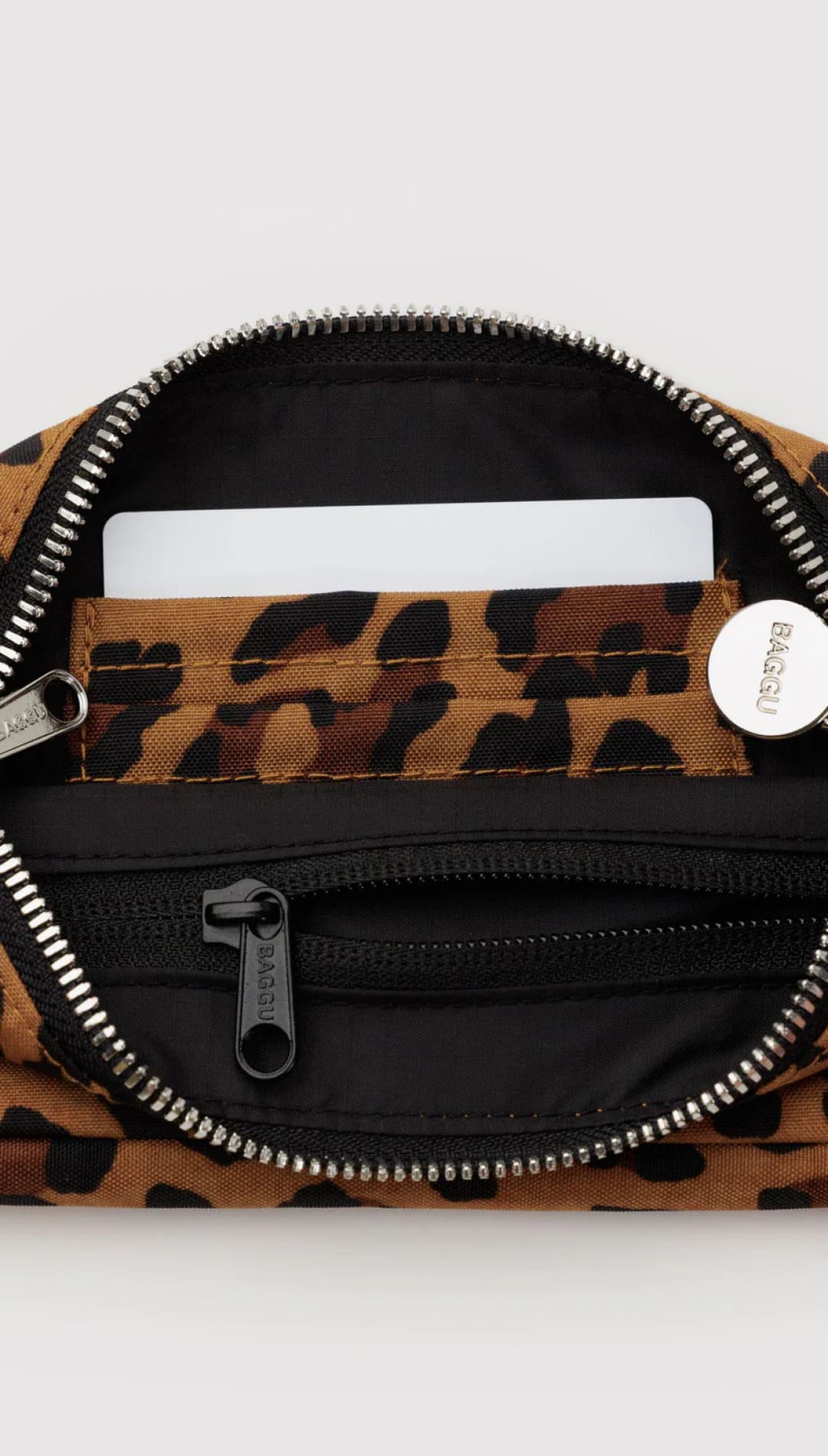 Leopard print fanny pack with black accents and silver hardware.