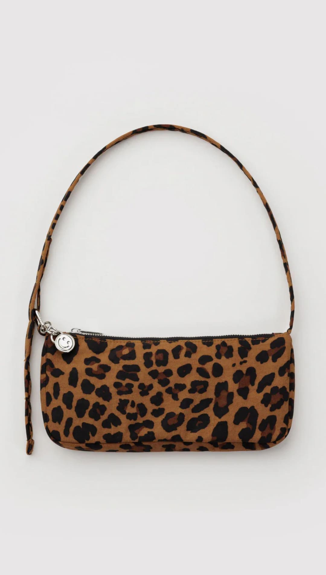 Leopard print handbag with a single shoulder strap and silver button closure.