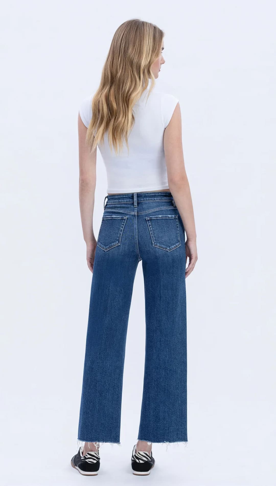 Women’s dark wash wide-leg jeans with a frayed hem.
