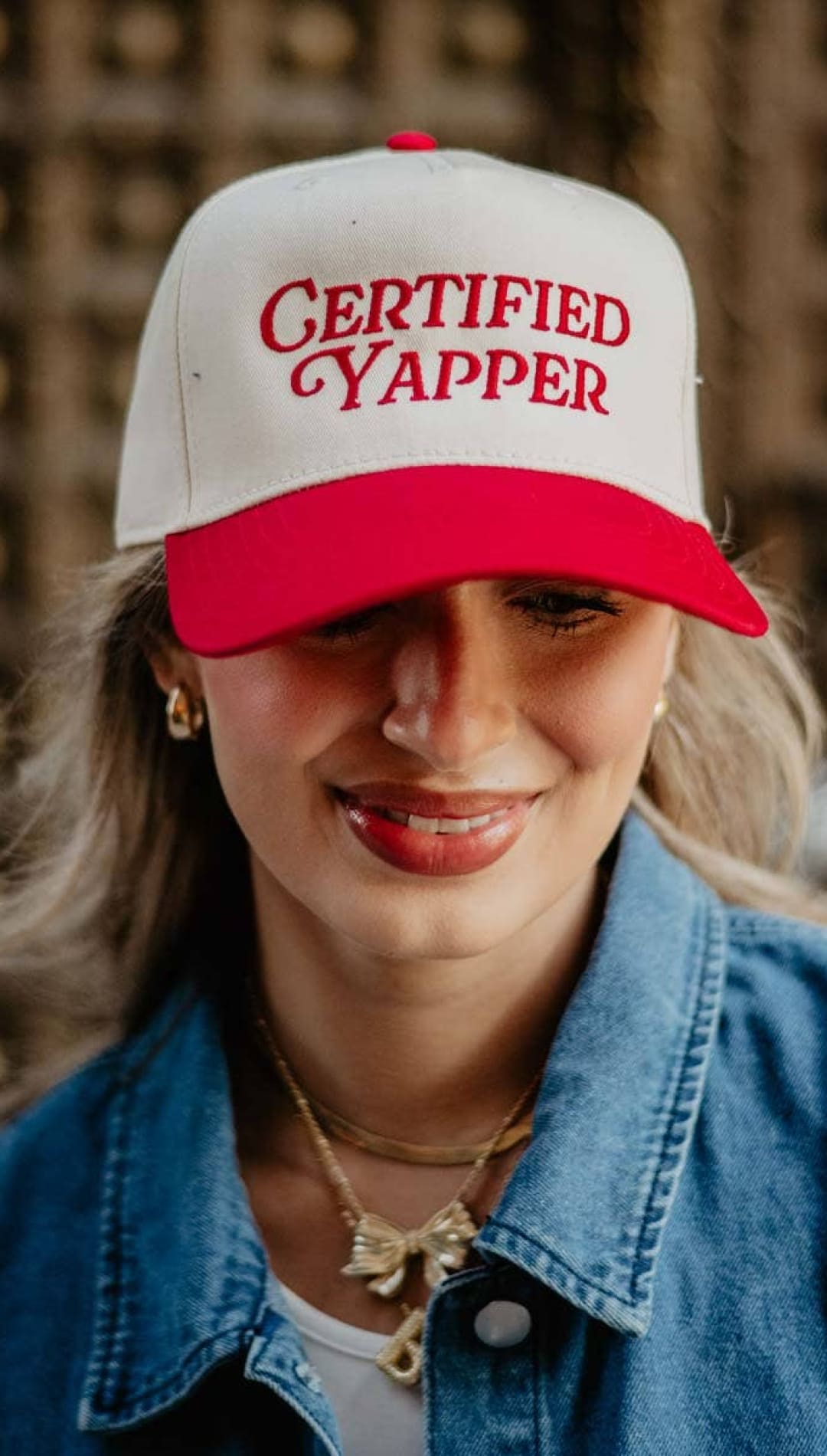 Certified cyapper trucker hat with red and white design, denim jacket