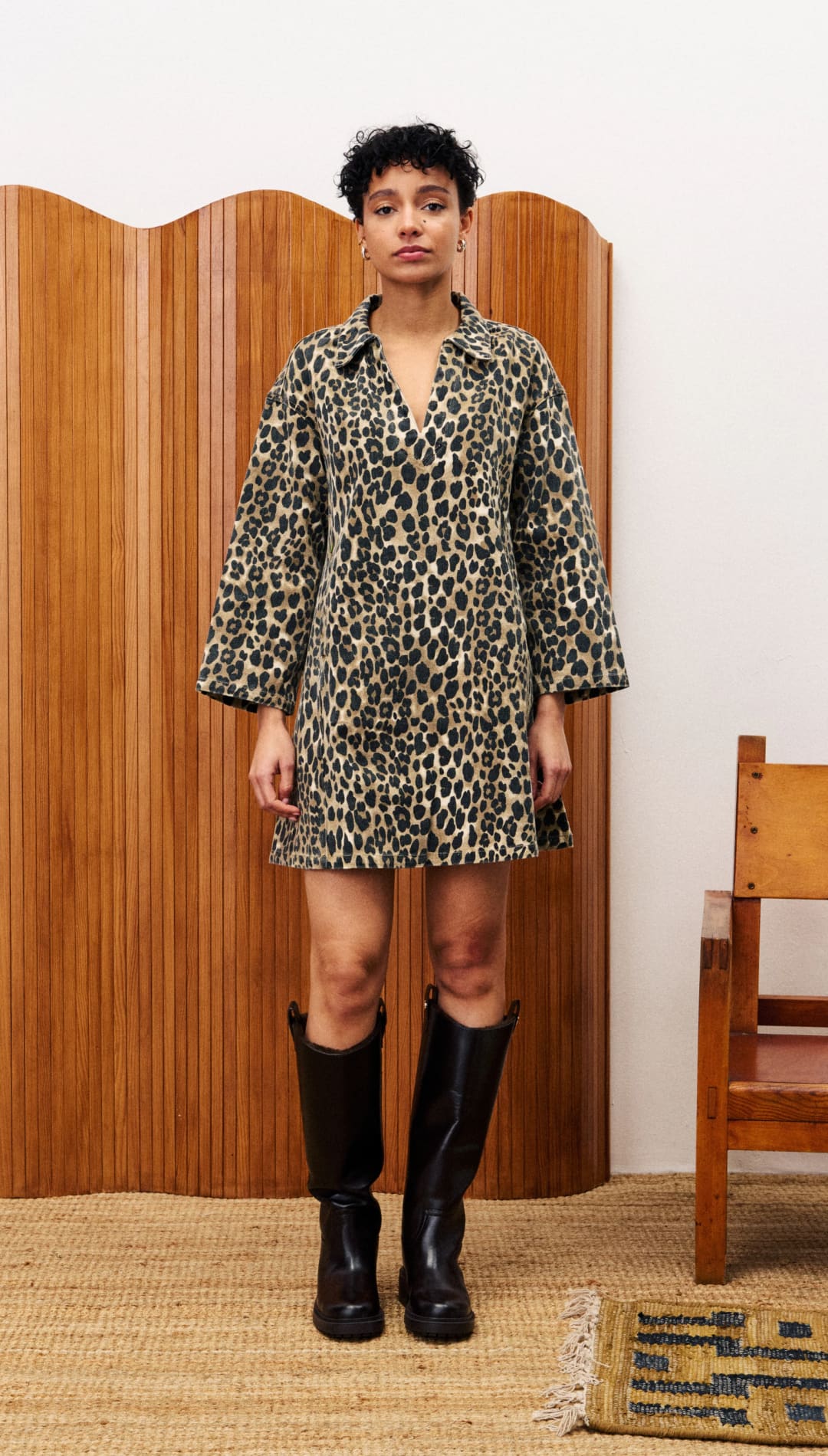 Leopard print mini dress with wide sleeves and a V-neck, paired with black knee-high boots.