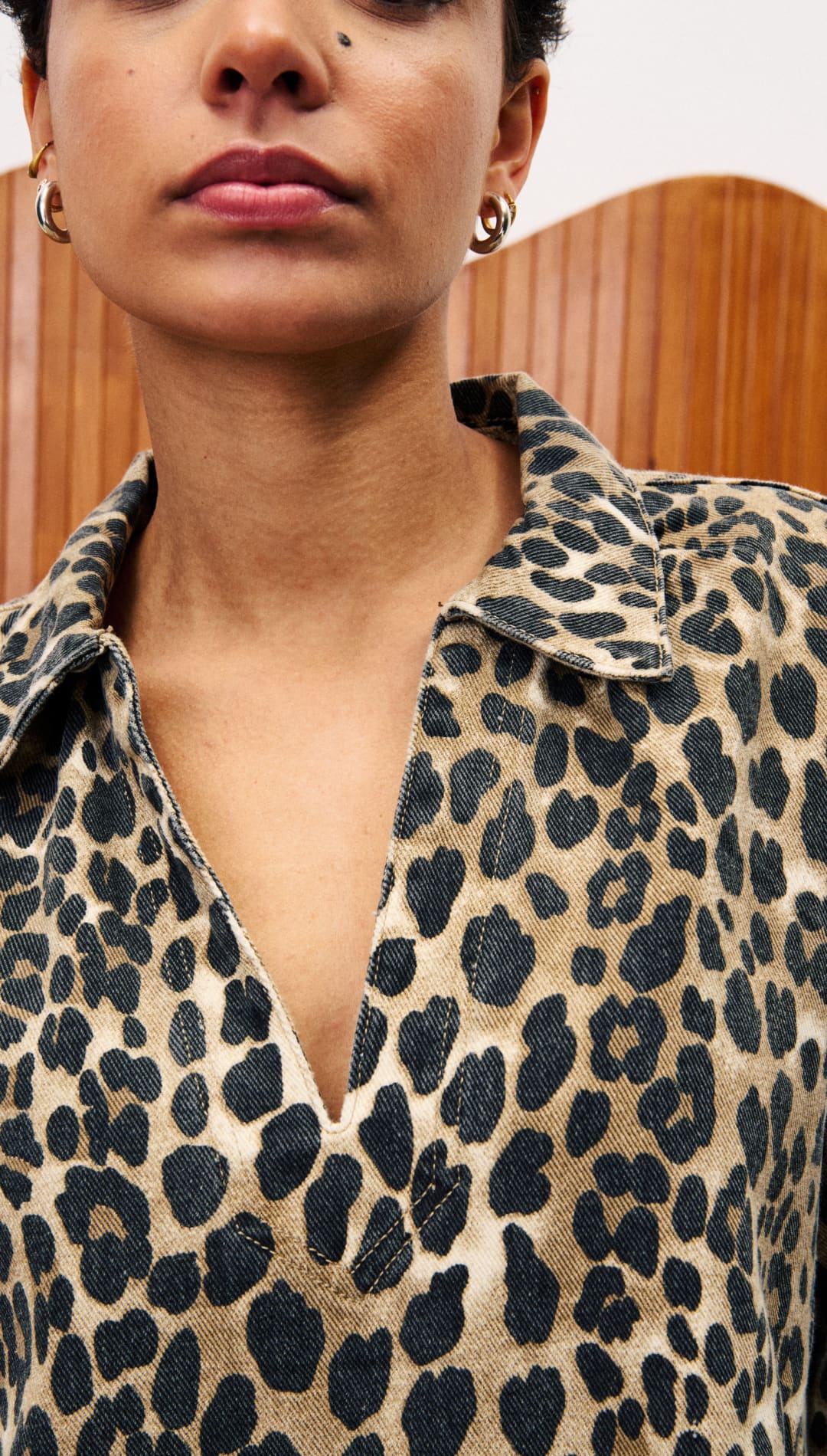 A short-sleeved collared shirt in a leopard print.