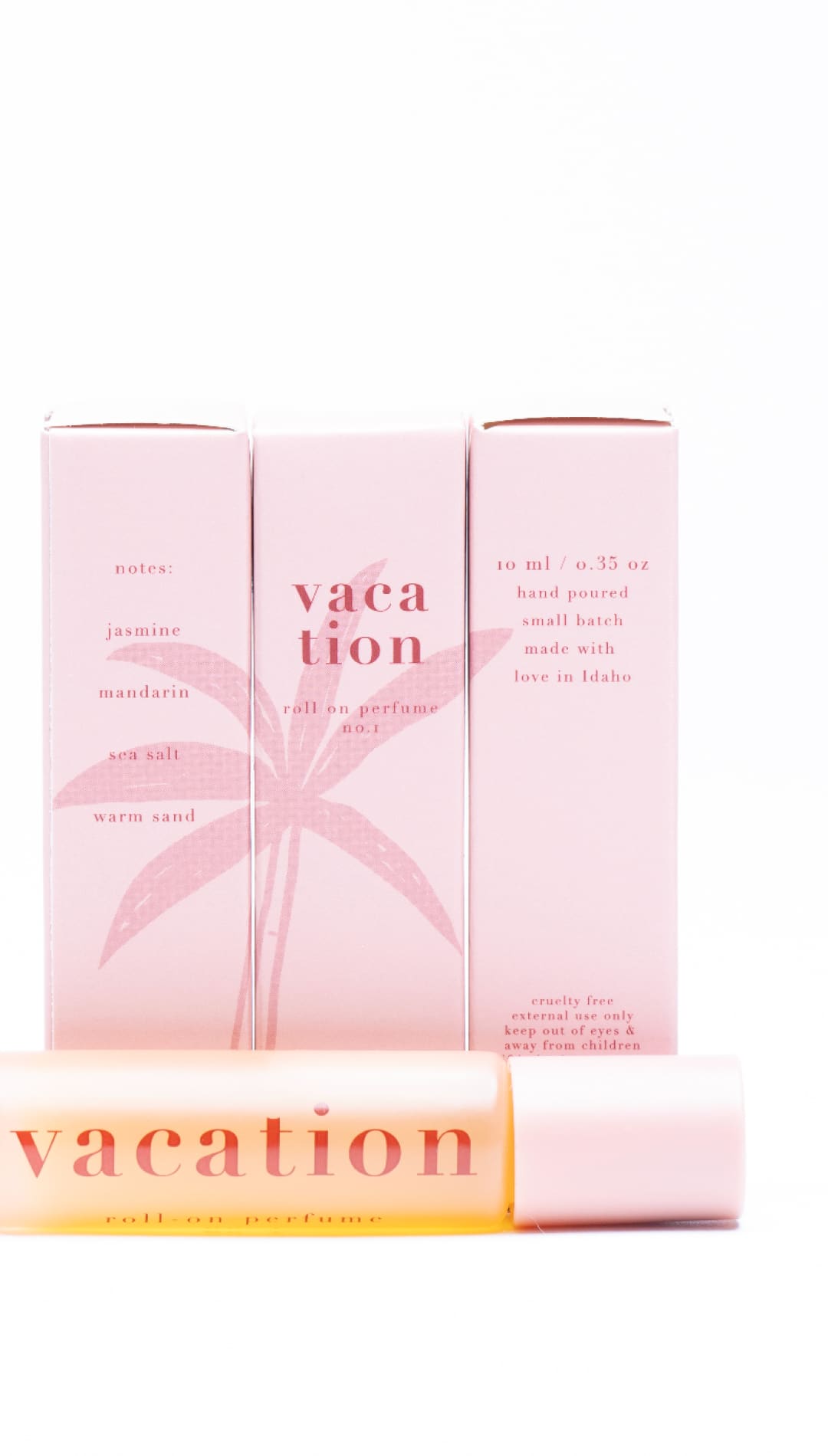 Vacation lip balm tube with pink and white design, featuring a palm tree motif.