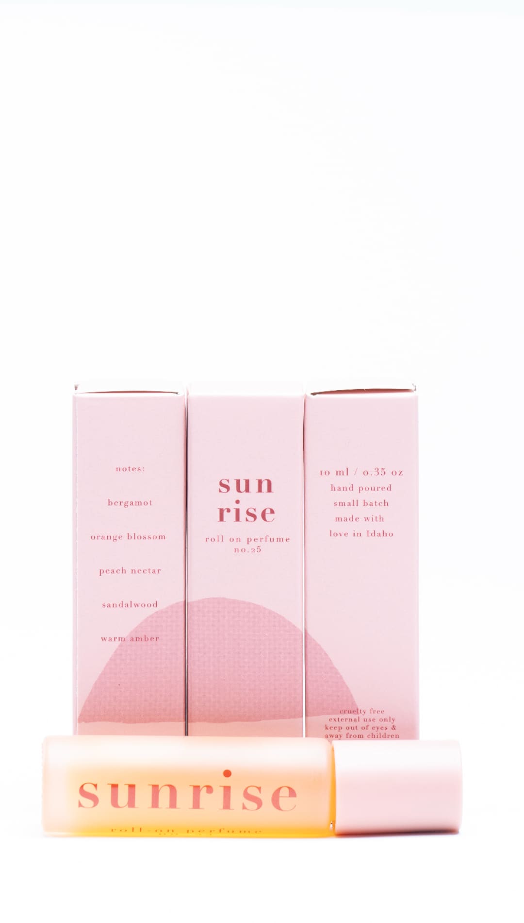 Pink and yellow sunrise candle set with minimalist design.