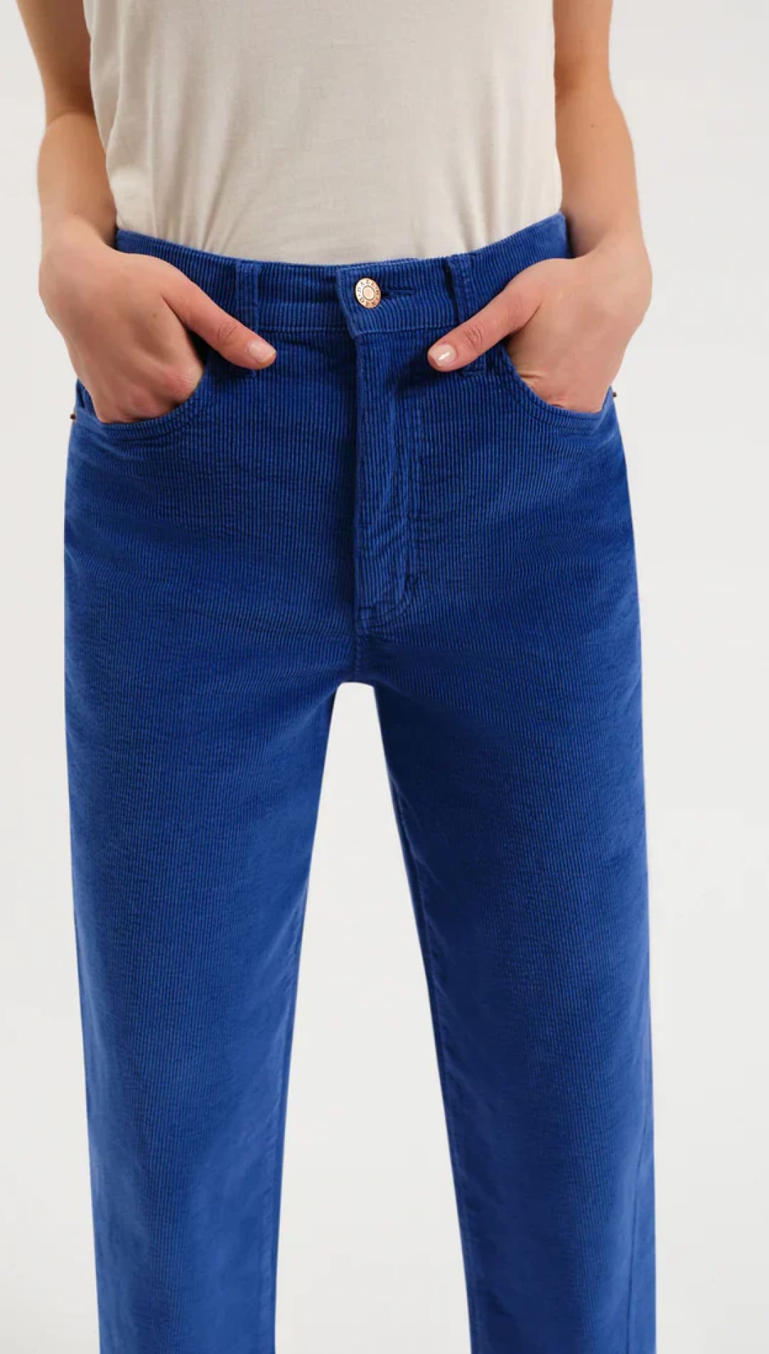 Royal blue corduroy pants with a high waist and button fly design.
