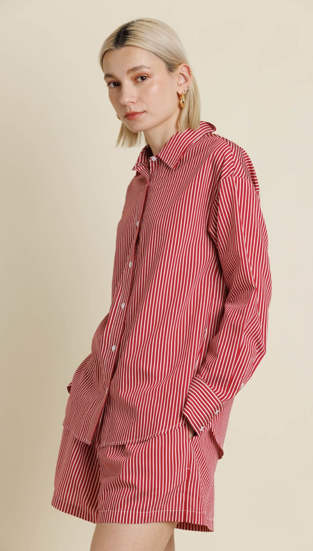 A red and white striped button-up shirt and matching shorts set.
