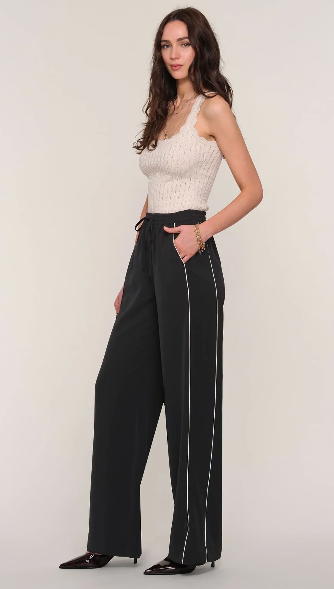 Black wide-leg track pants with white side stripes