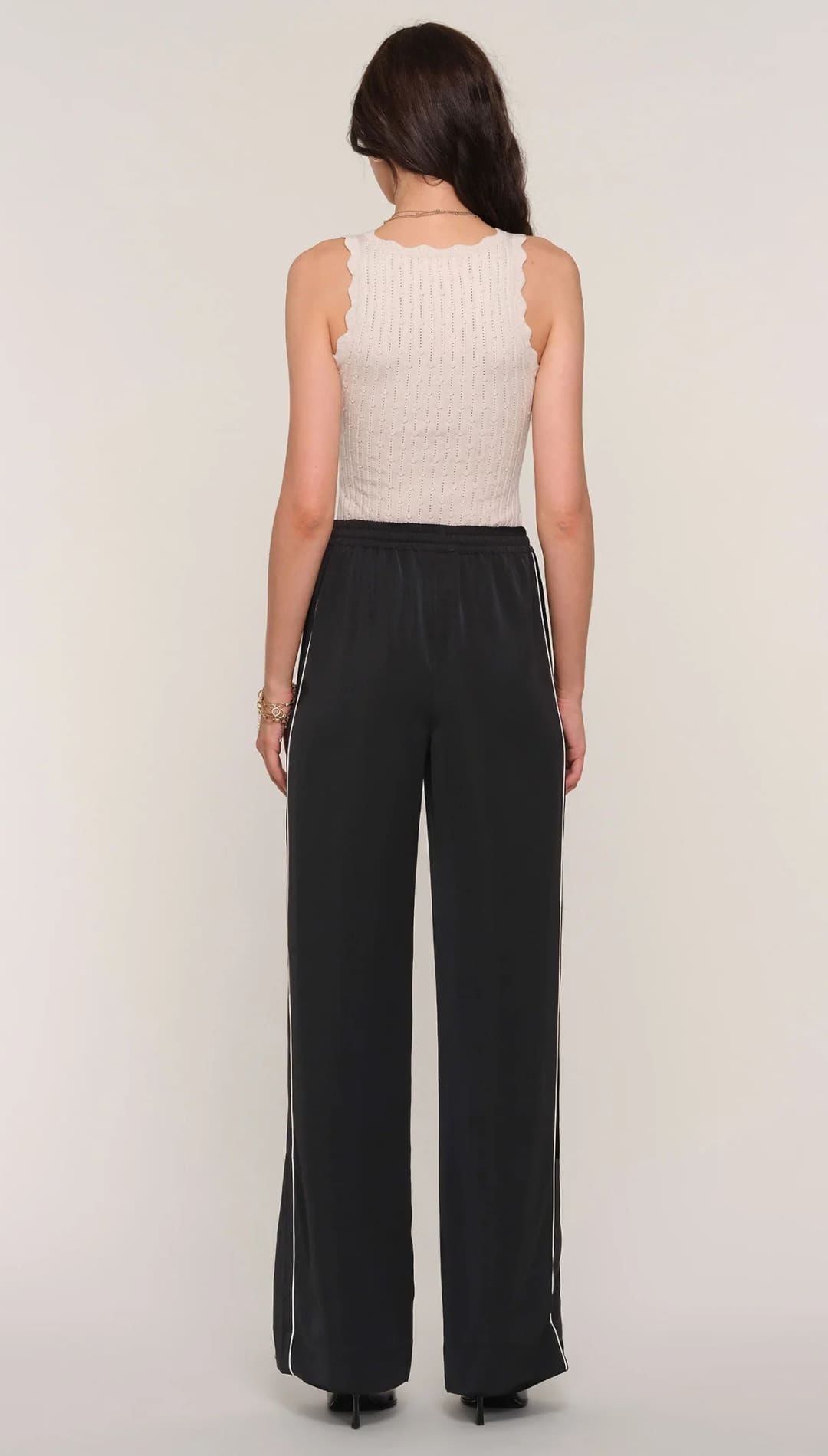 Women’s ribbed knit tank top and wide-leg track pants.