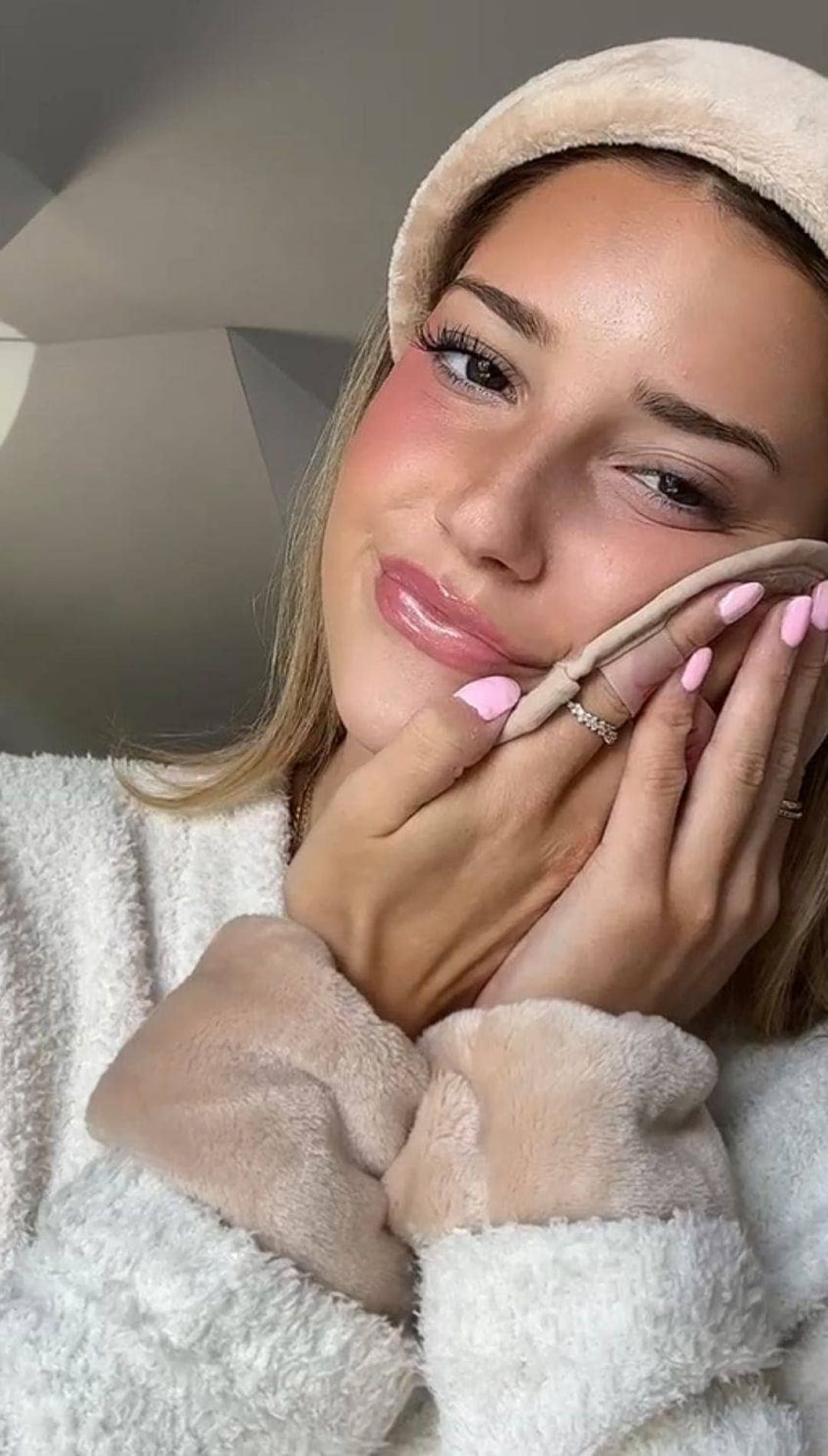 Beige plush beanie with a soft, fuzzy texture and ribbed brim.