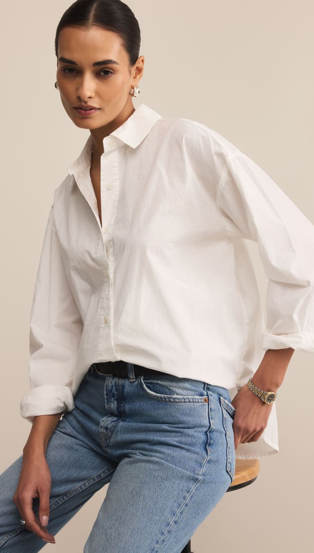 White oversized poplin shirt with balloon sleeves and button-down collar.