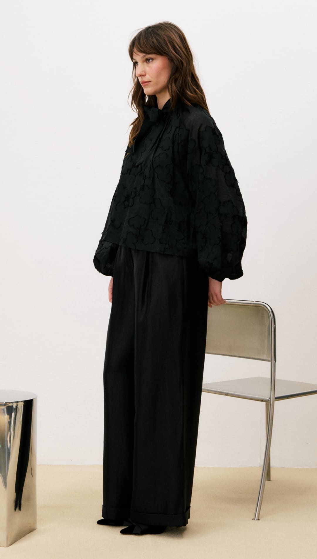 Black wide-leg pants with a relaxed fit and high waist.