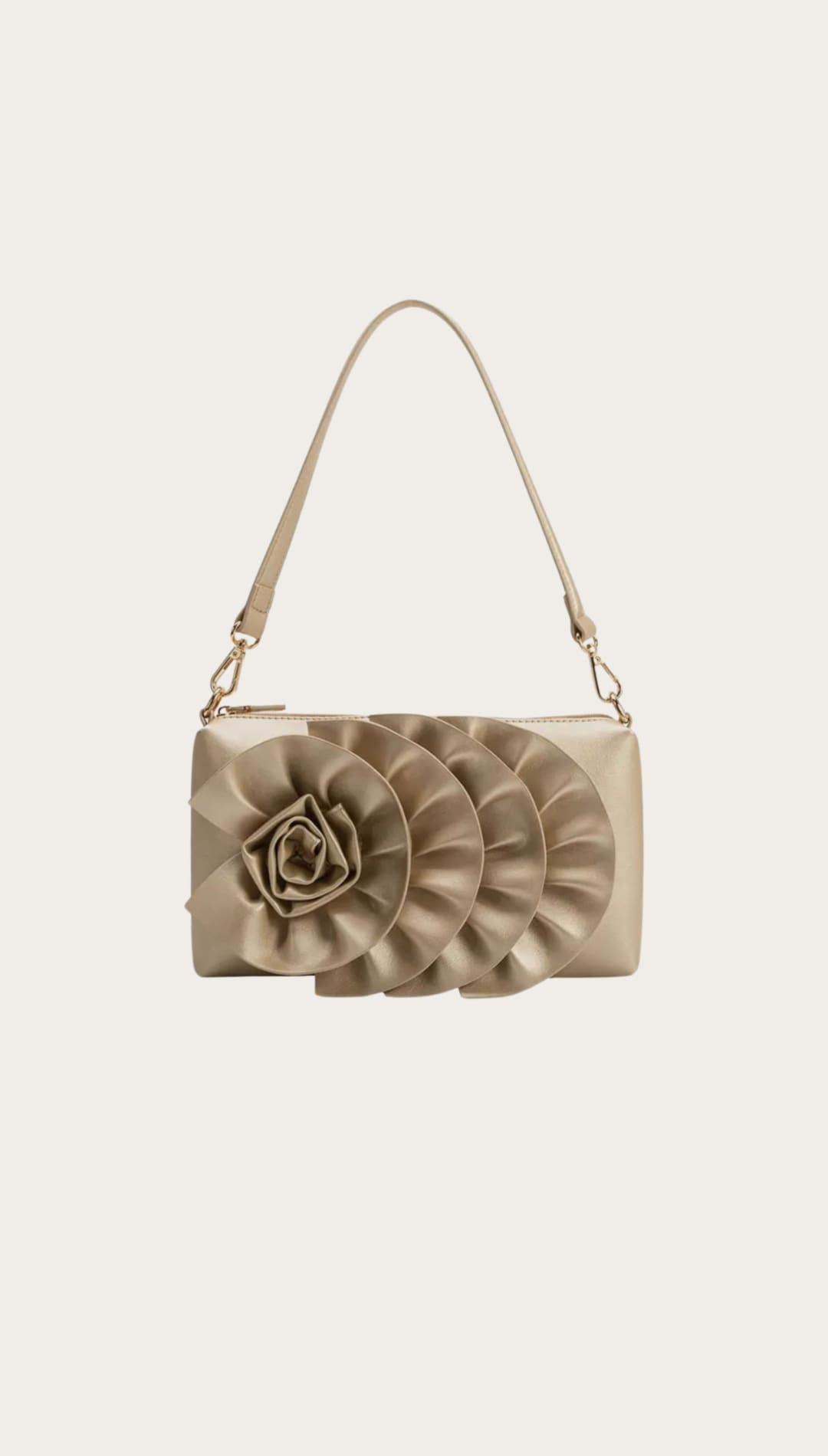 Gold-toned handbag with floral embellishment.