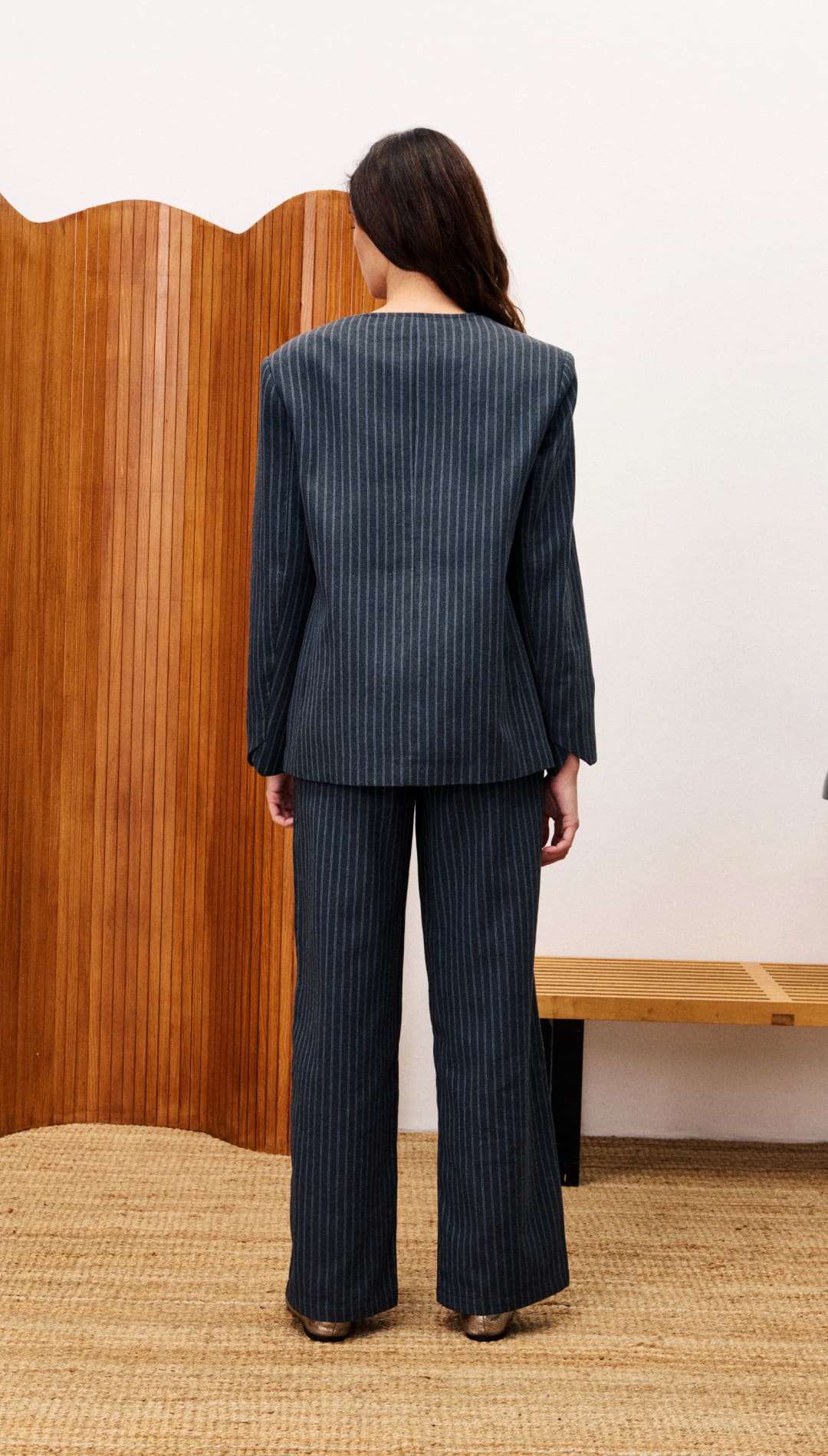 Women’s dark pinstriped pantsuit.