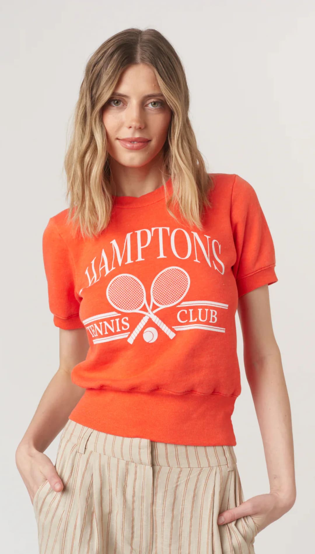 Orange tennis club sweatshirt.