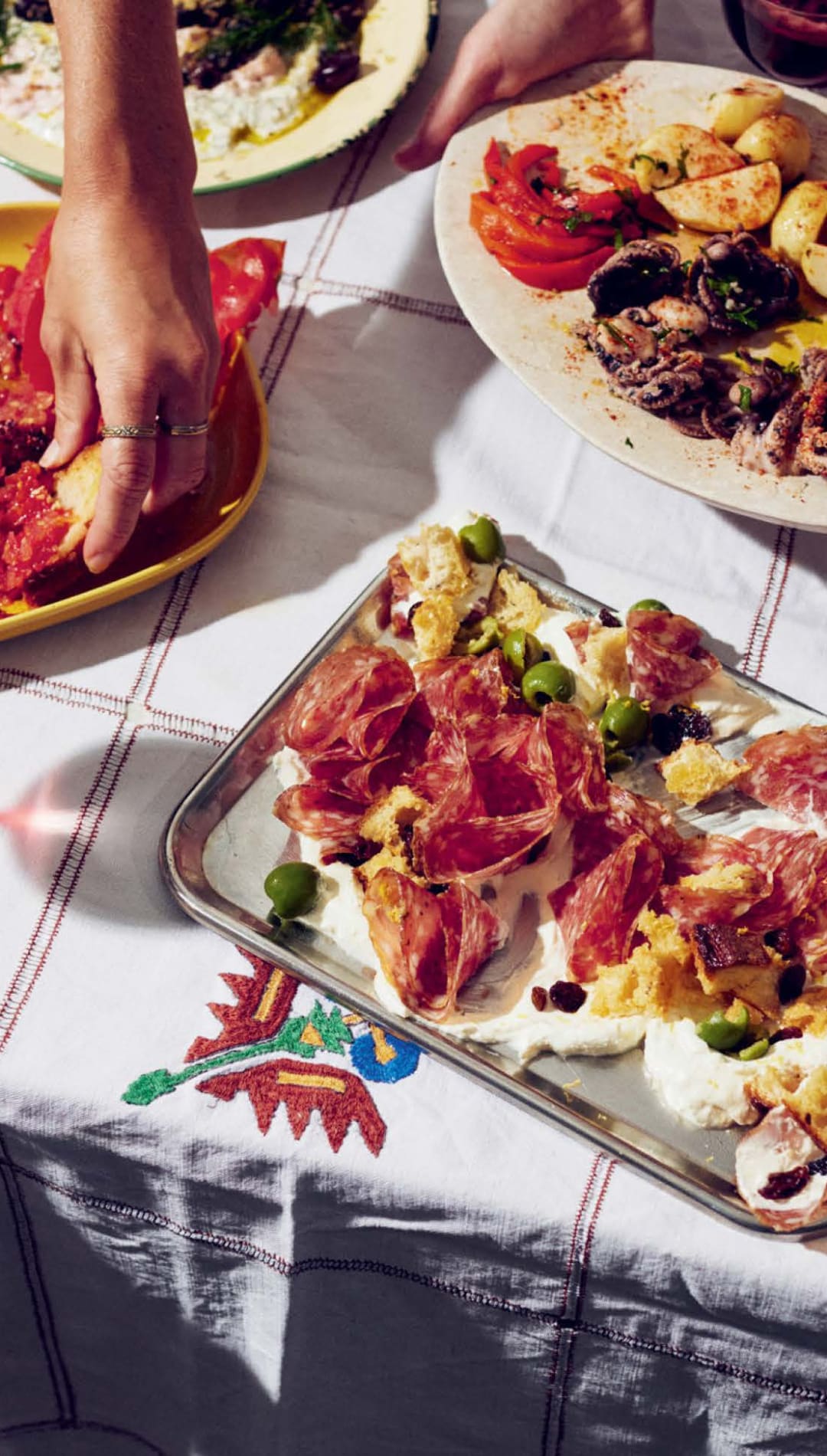 White and red patterned tablecloth with floral design