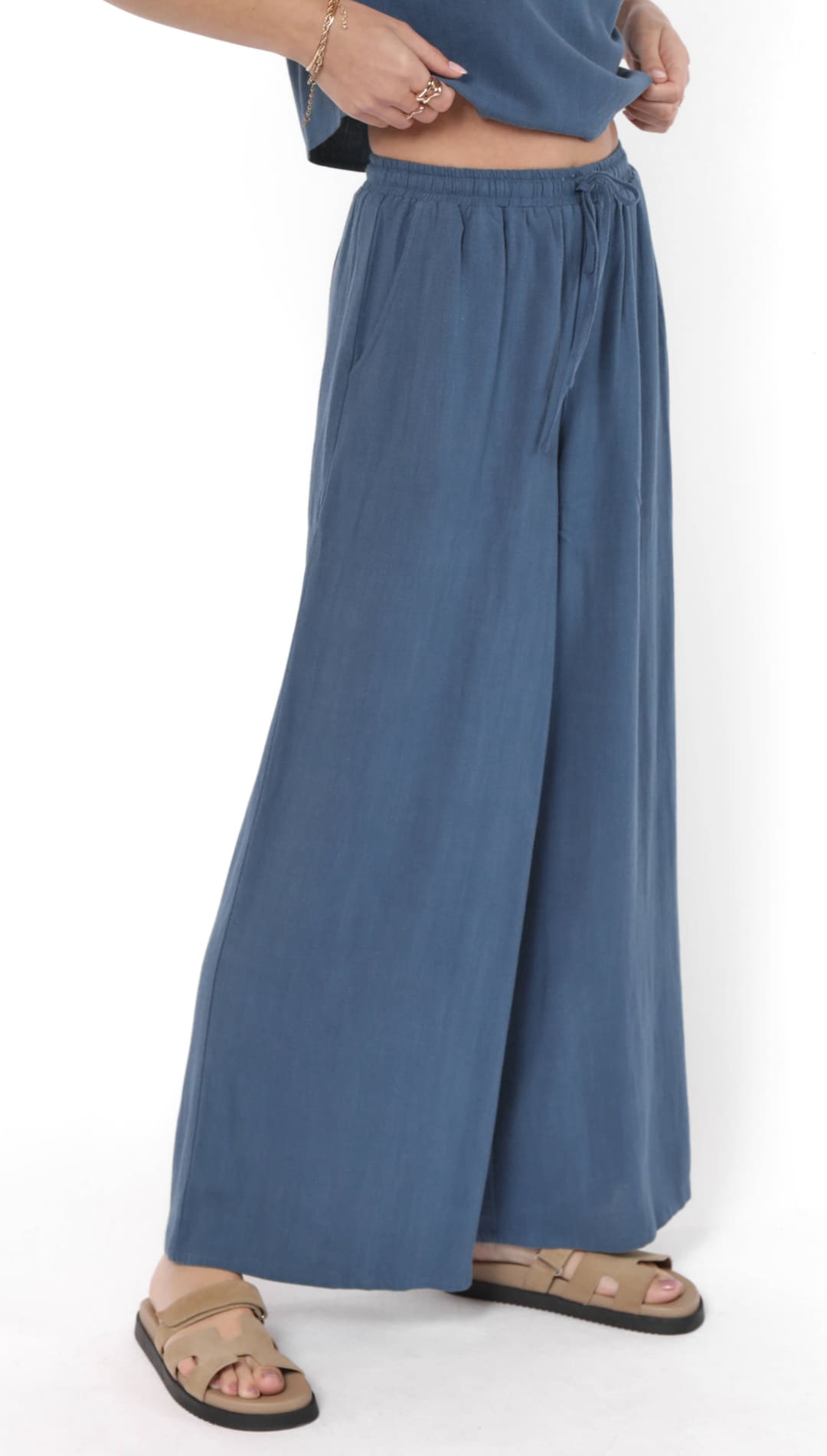 Flowy, wide-leg blue palazzo pants with a drawstring waist.