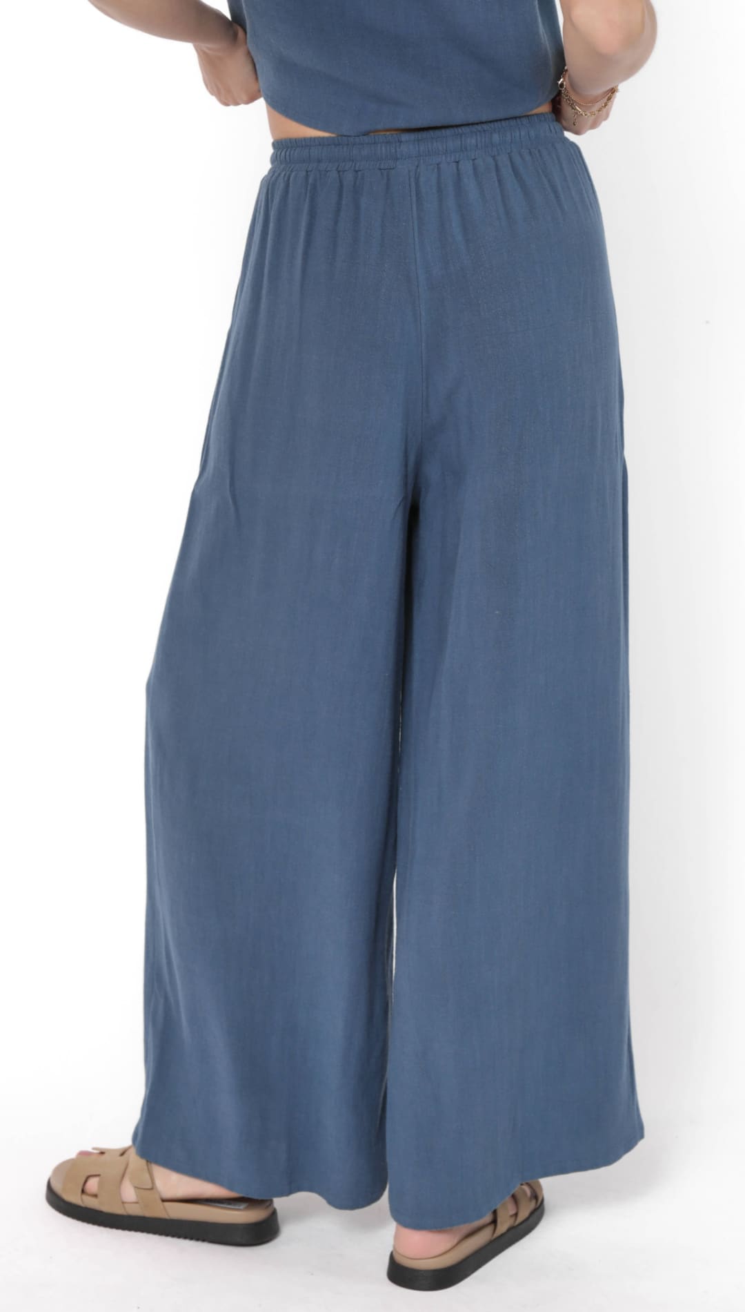 Loose-fitting, wide-leg blue pants with an elastic waistband.