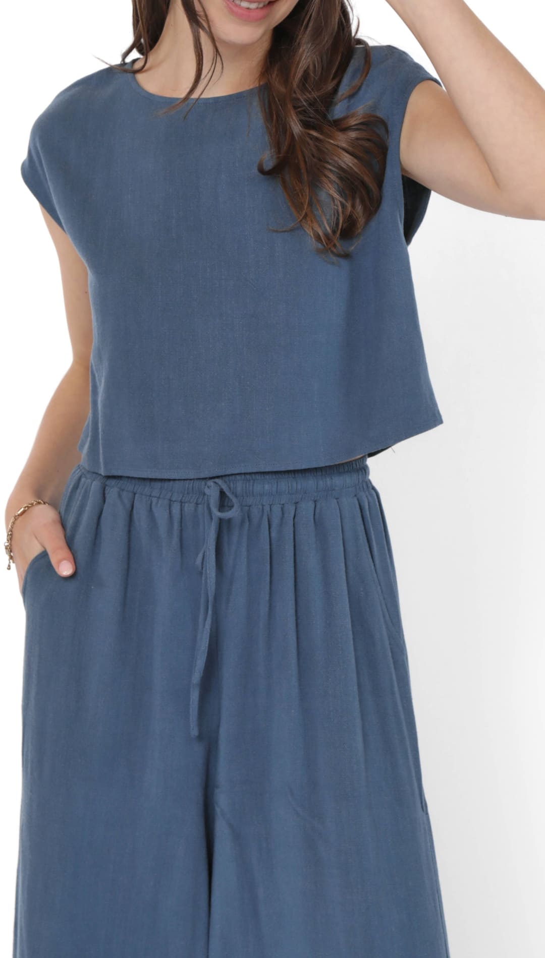 A woman’s blue two-piece crop top and wide-leg pants set.