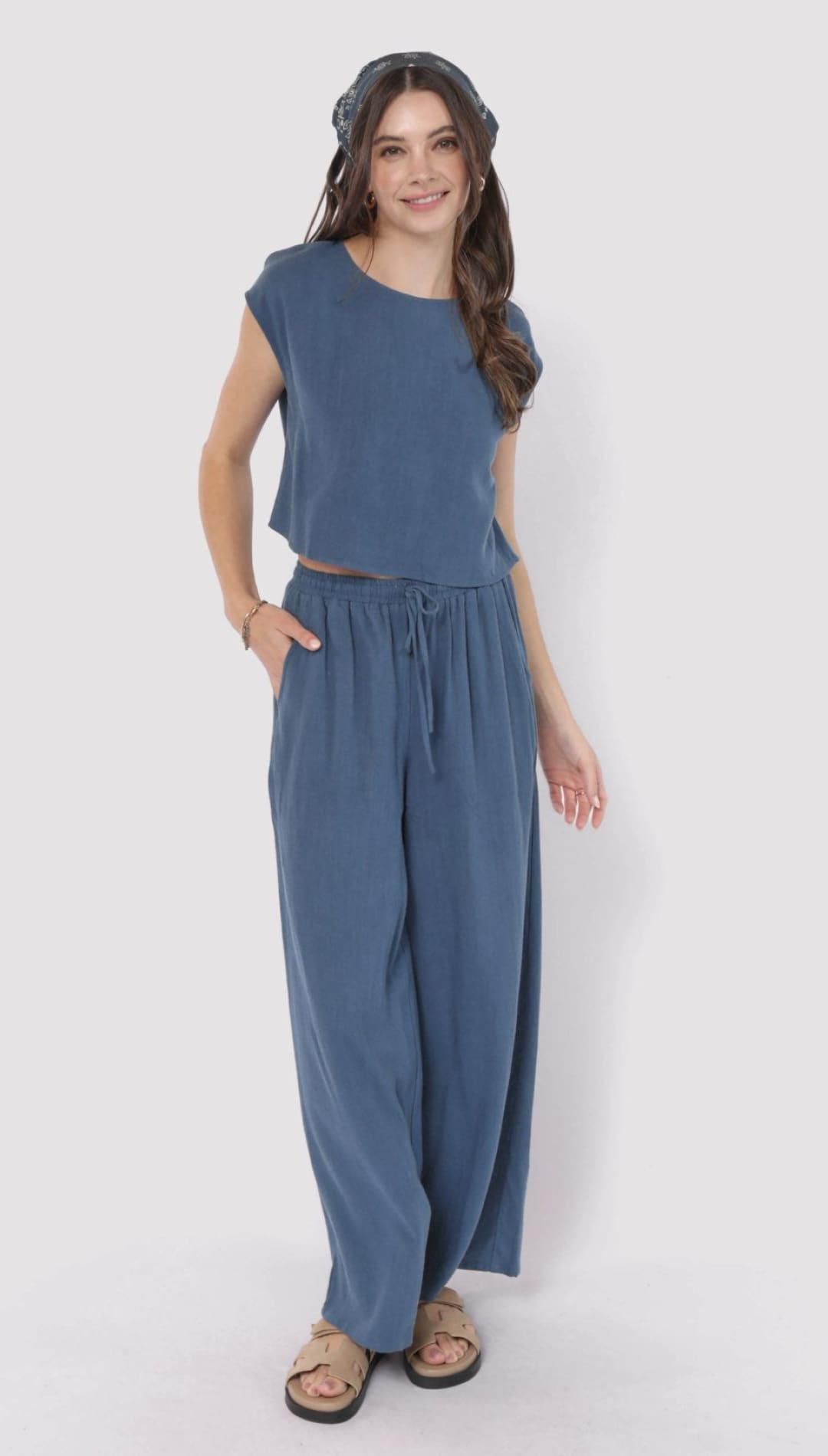 Woman in blue two-piece outfit.