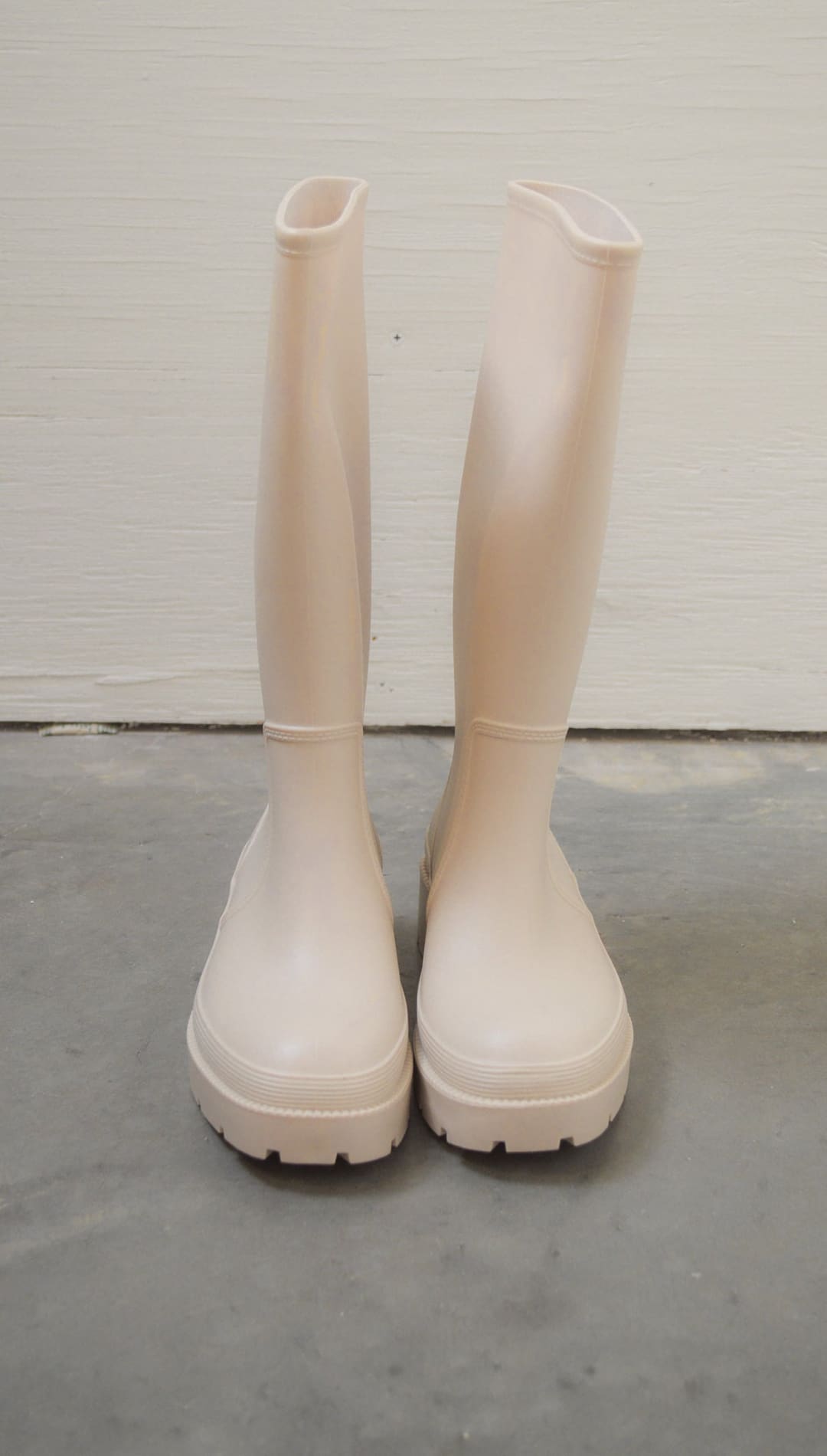 Pair of light pink rain boots.