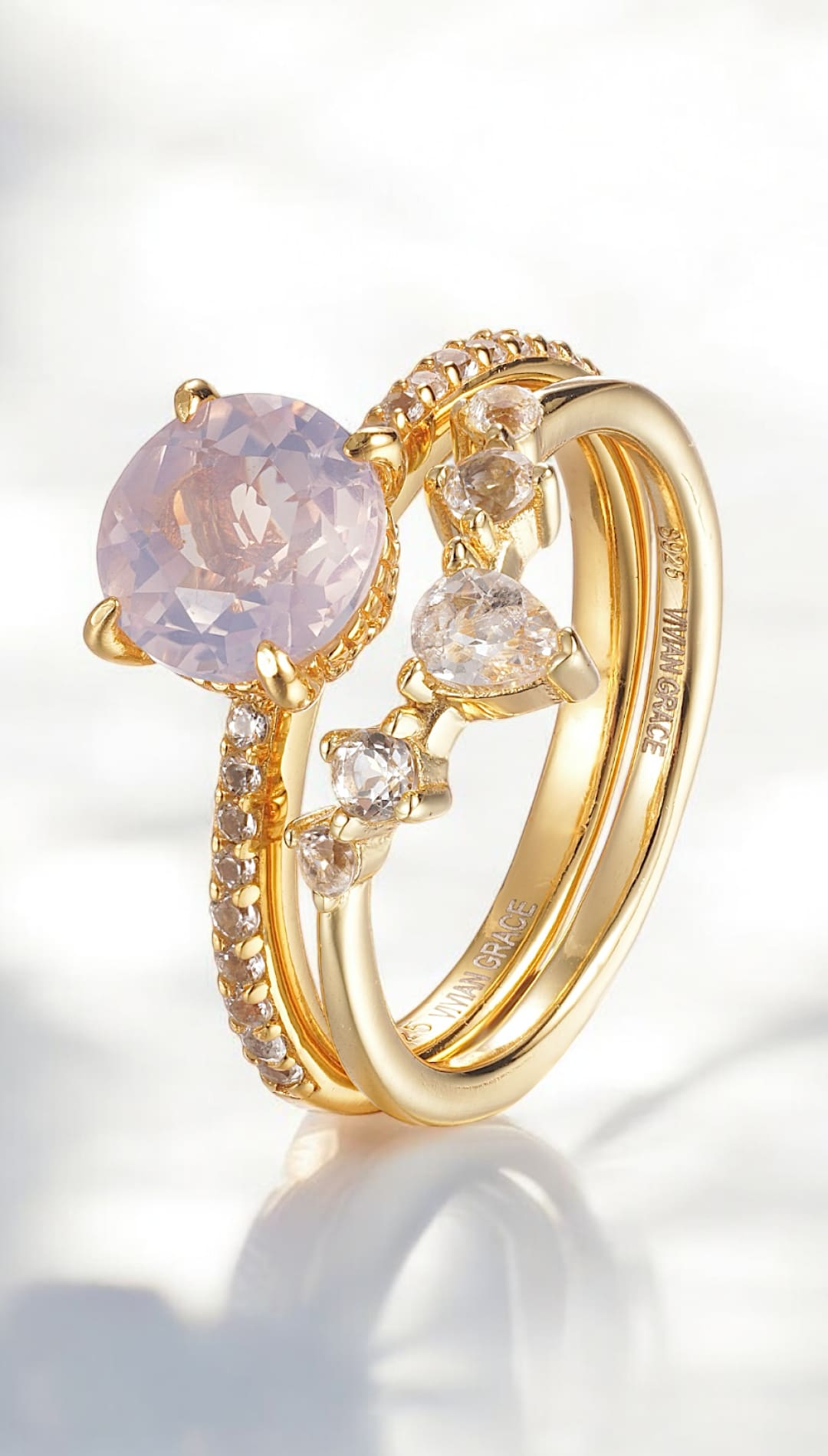 Gold ring set with pink gemstone and diamonds.