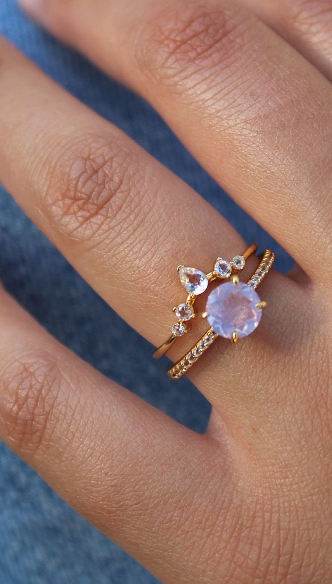 Gold rings with moonstone and diamond accents.