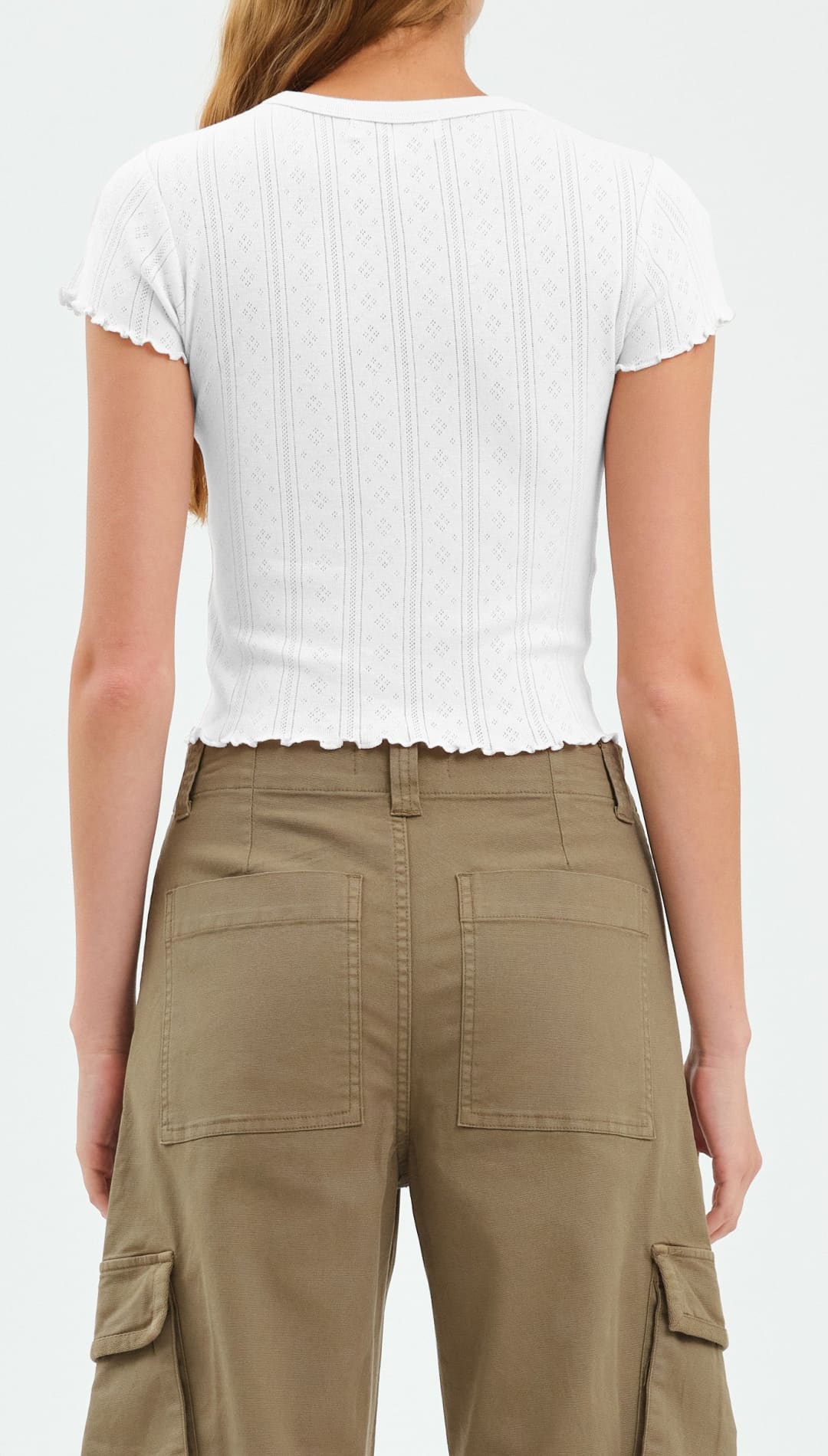 White ribbed crop top with khaki cargo pants.