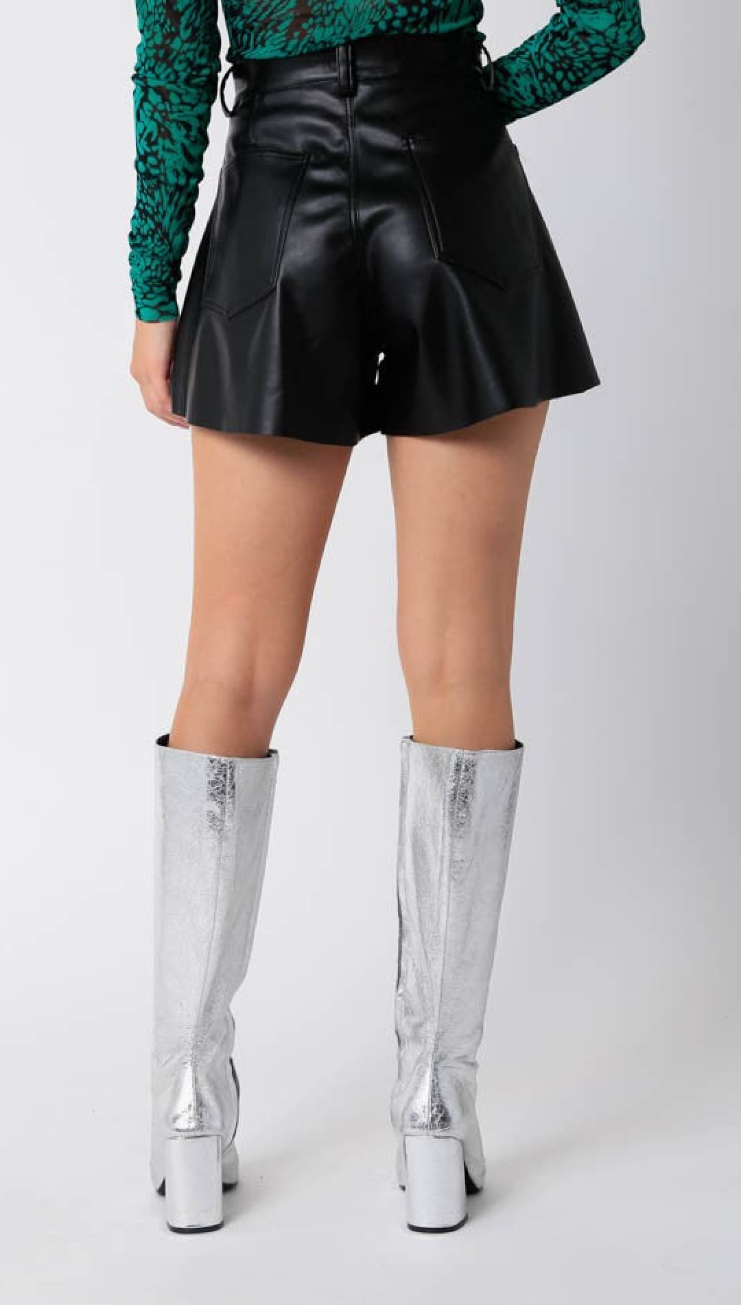 Black faux leather flared shorts with a high waist.