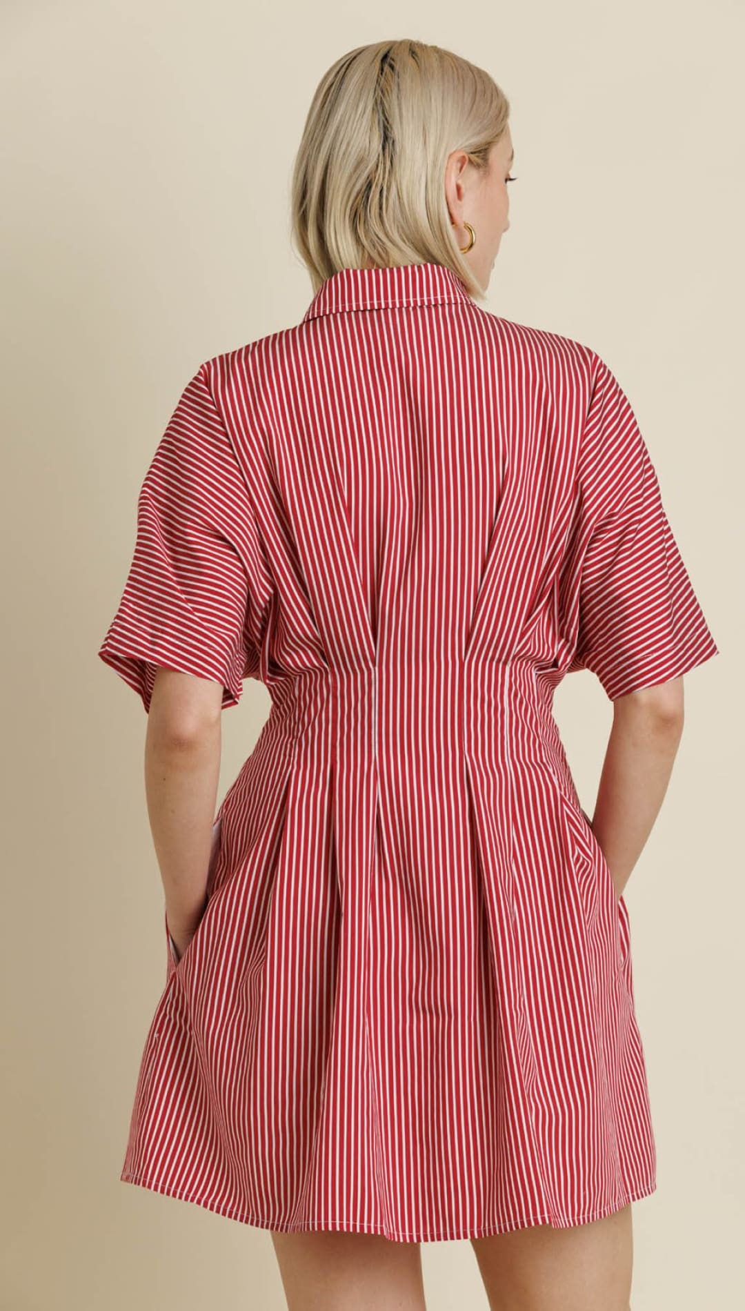 Red and white striped short-sleeved collared dress with a cinched waist and pleated skirt.