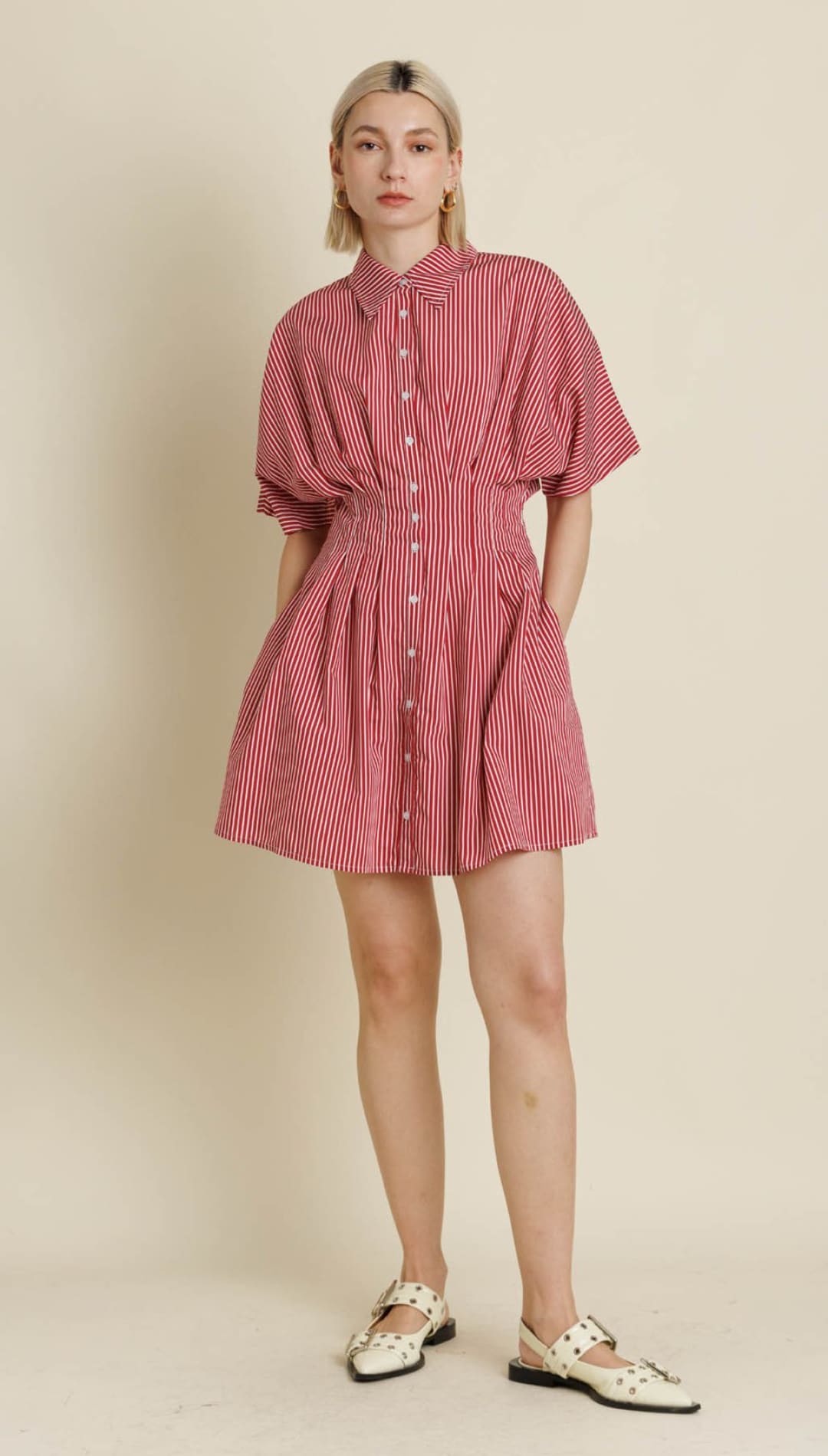 A red and white striped button-down mini dress with a cinched waist, puffed sleeves, and a flared skirt.