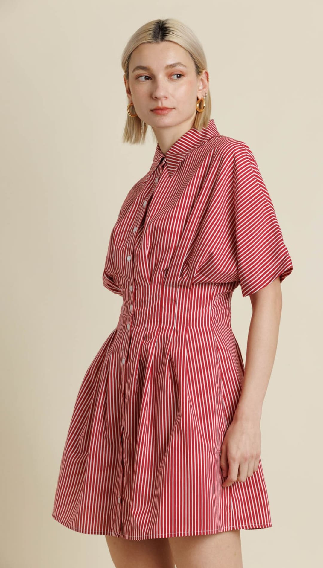 A short-sleeved, collared red and white striped mini dress with a fitted waist and pleated skirt.