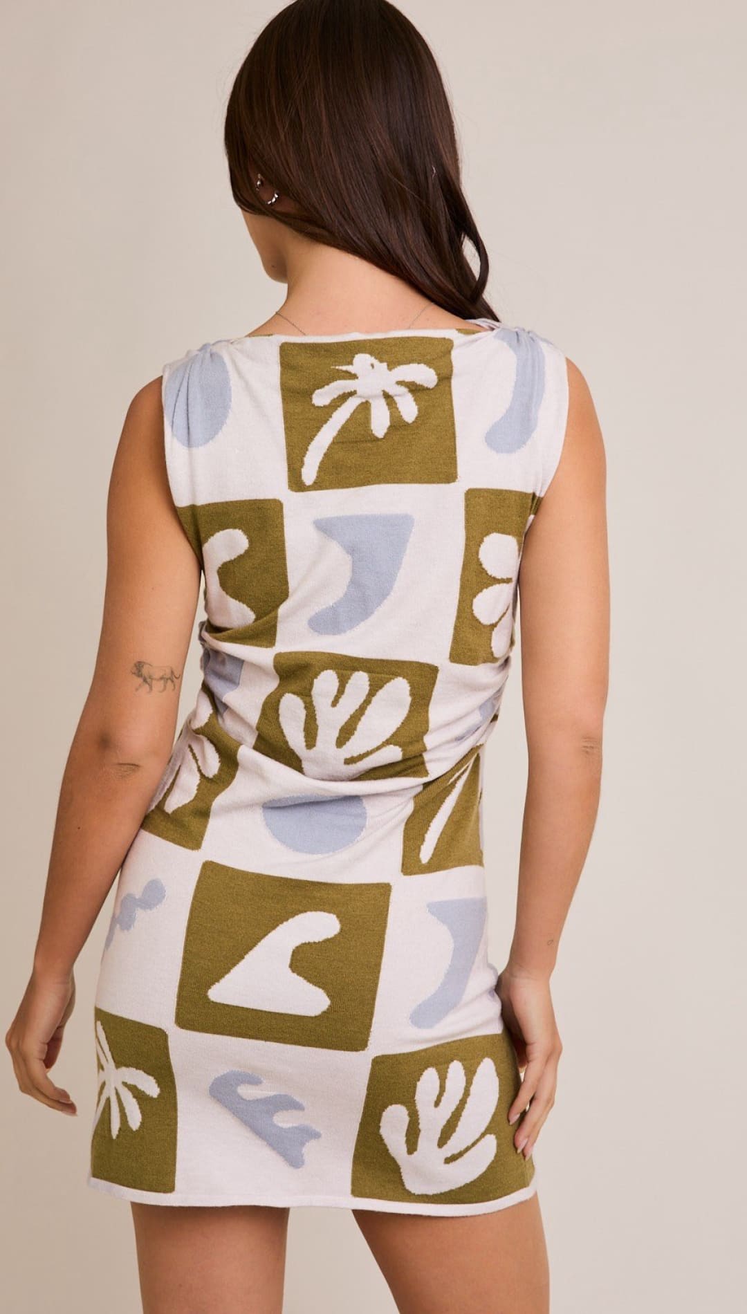 Sleeveless mini dress with a square pattern.