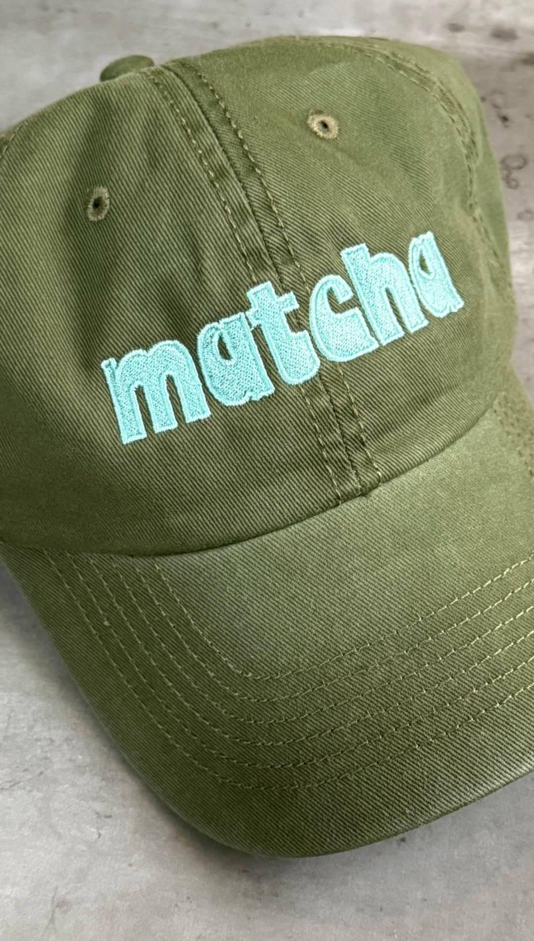 Olive green baseball cap.