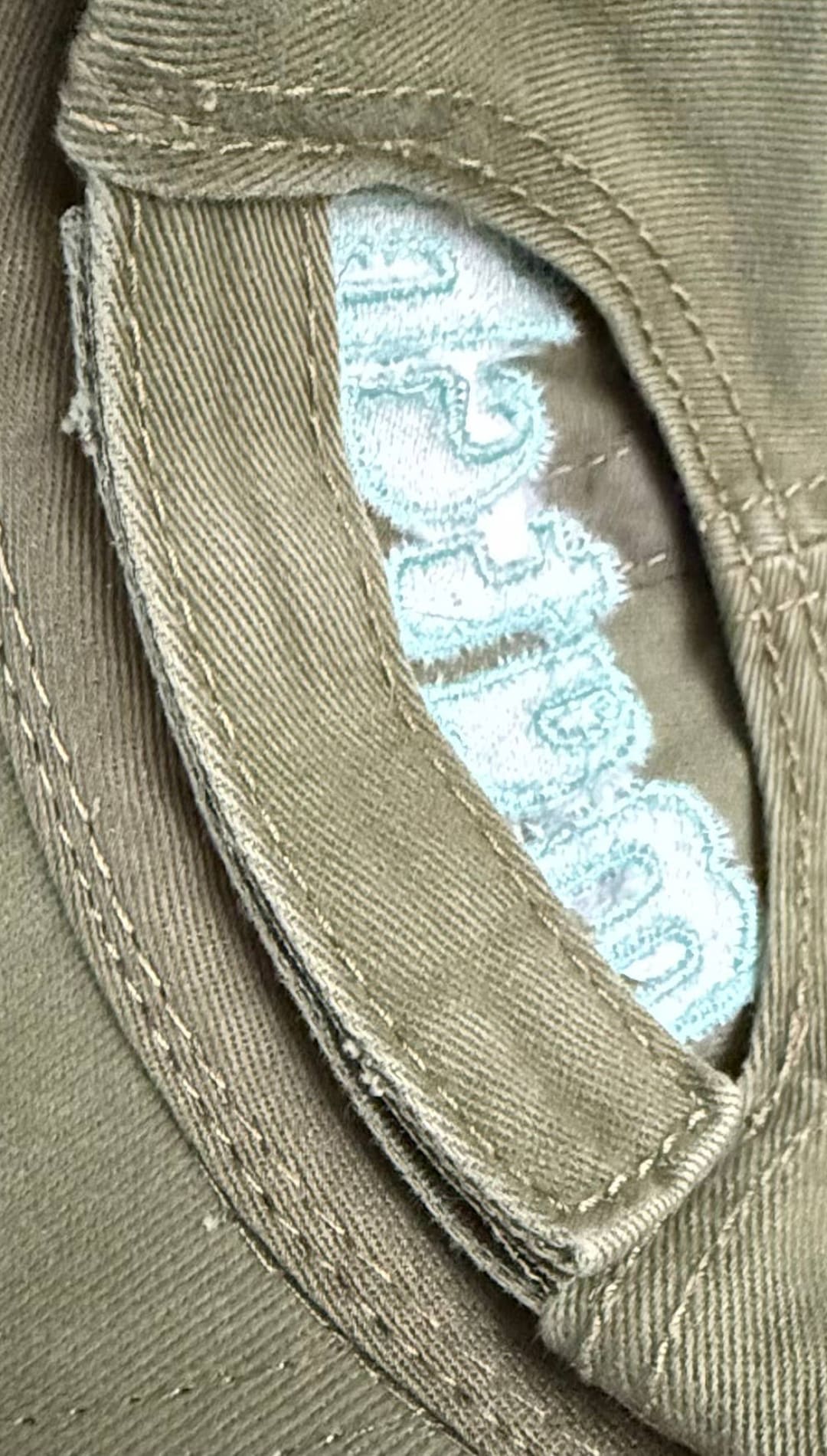 Olive green baseball cap.