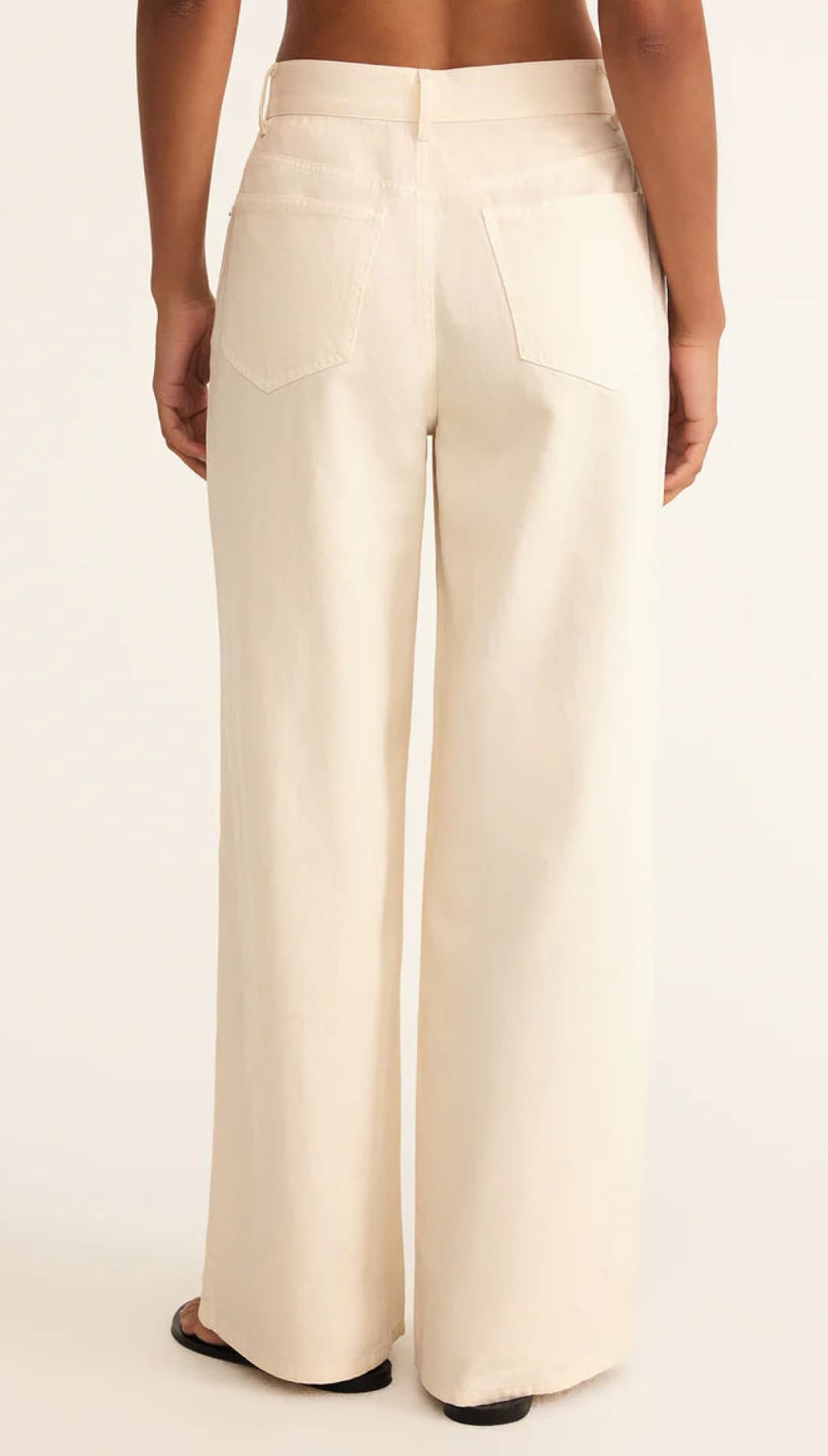 Cream-colored wide-leg pants with a high waist and structured design.