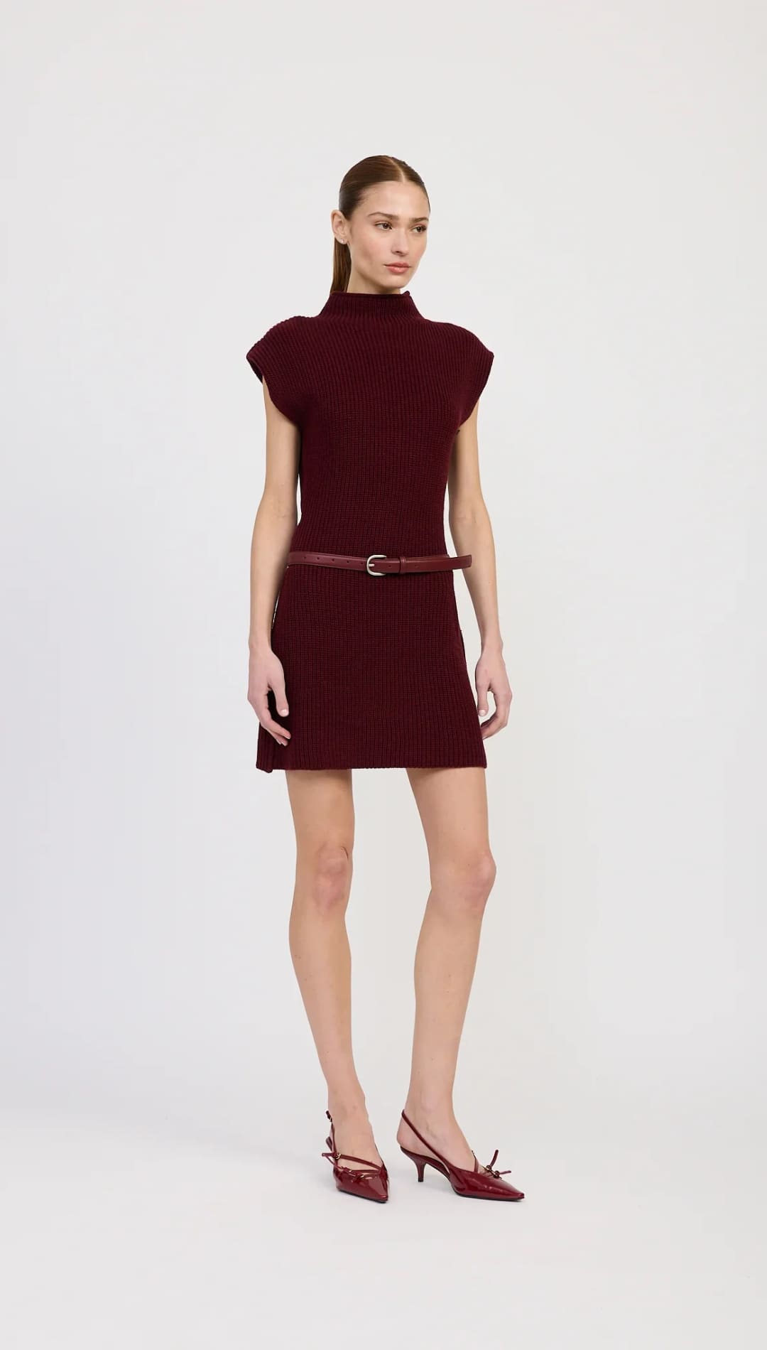 Burgundy mock-neck mini dress with cap sleeves and a thin belt.