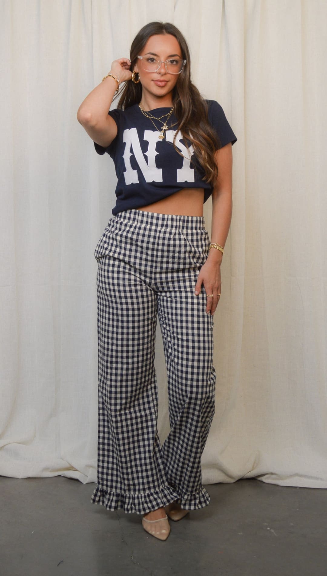 Women’s black and white gingham wide-leg pants with ruffled cuffs.
