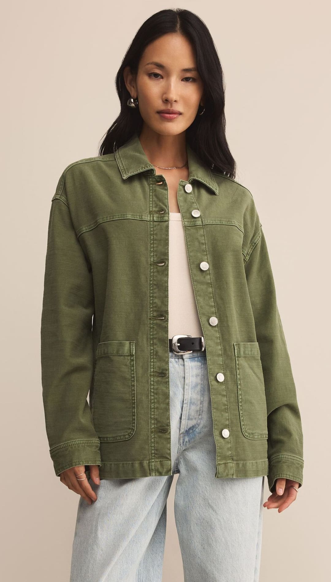 An olive green utility jacket with large buttons and front pockets.