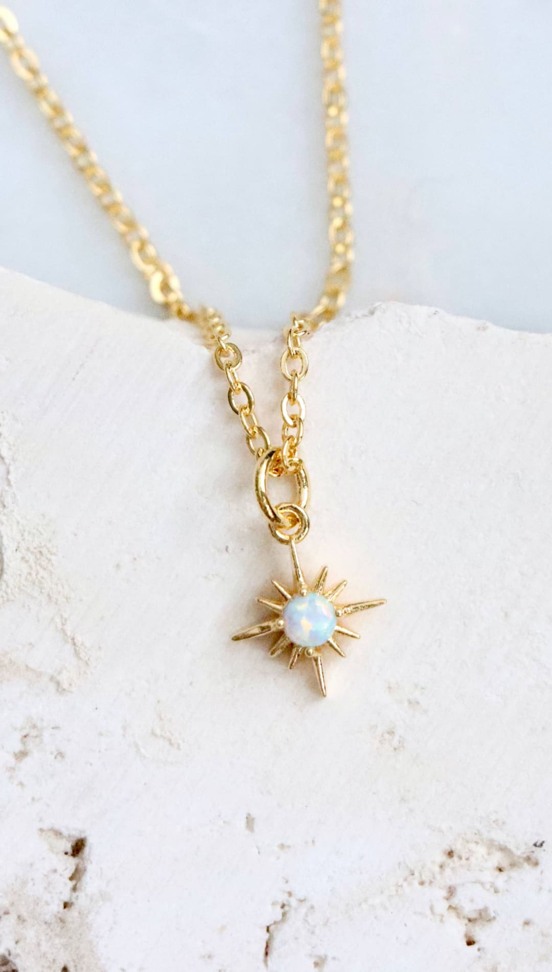 Gold starburst pendant necklace.