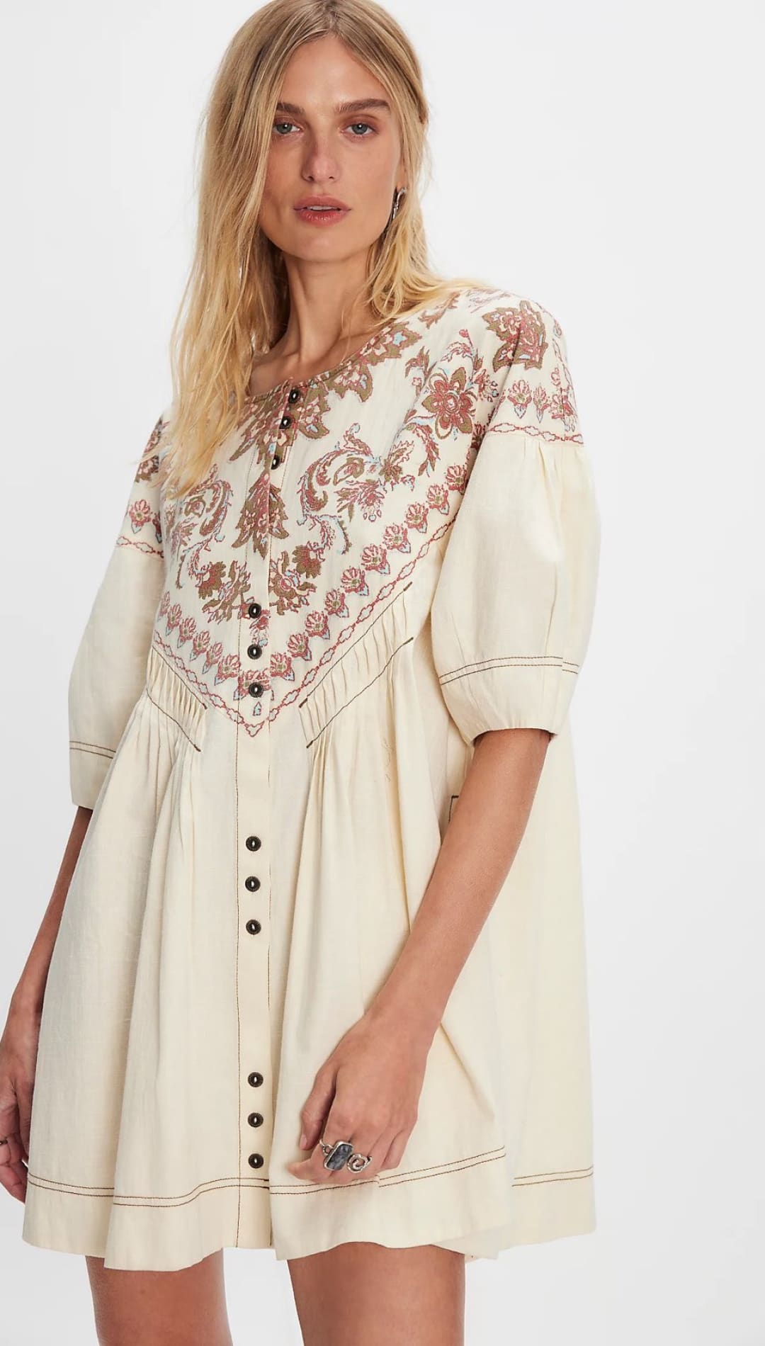 Cream-colored, button-down dress with floral embroidery.